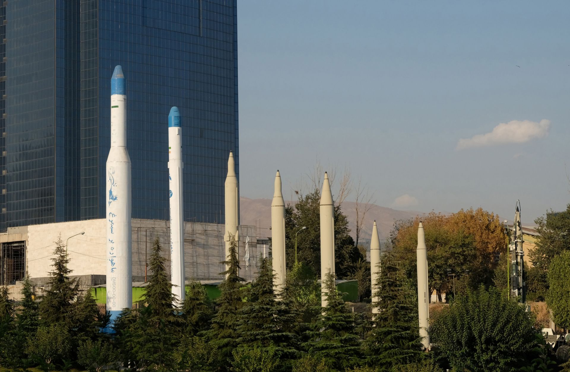 Iranian-made satellite carriers (left) and missiles (right) are displayed in front of the Holy Defense Museum in Tehran, Iran, on Sept. 20, 2020.