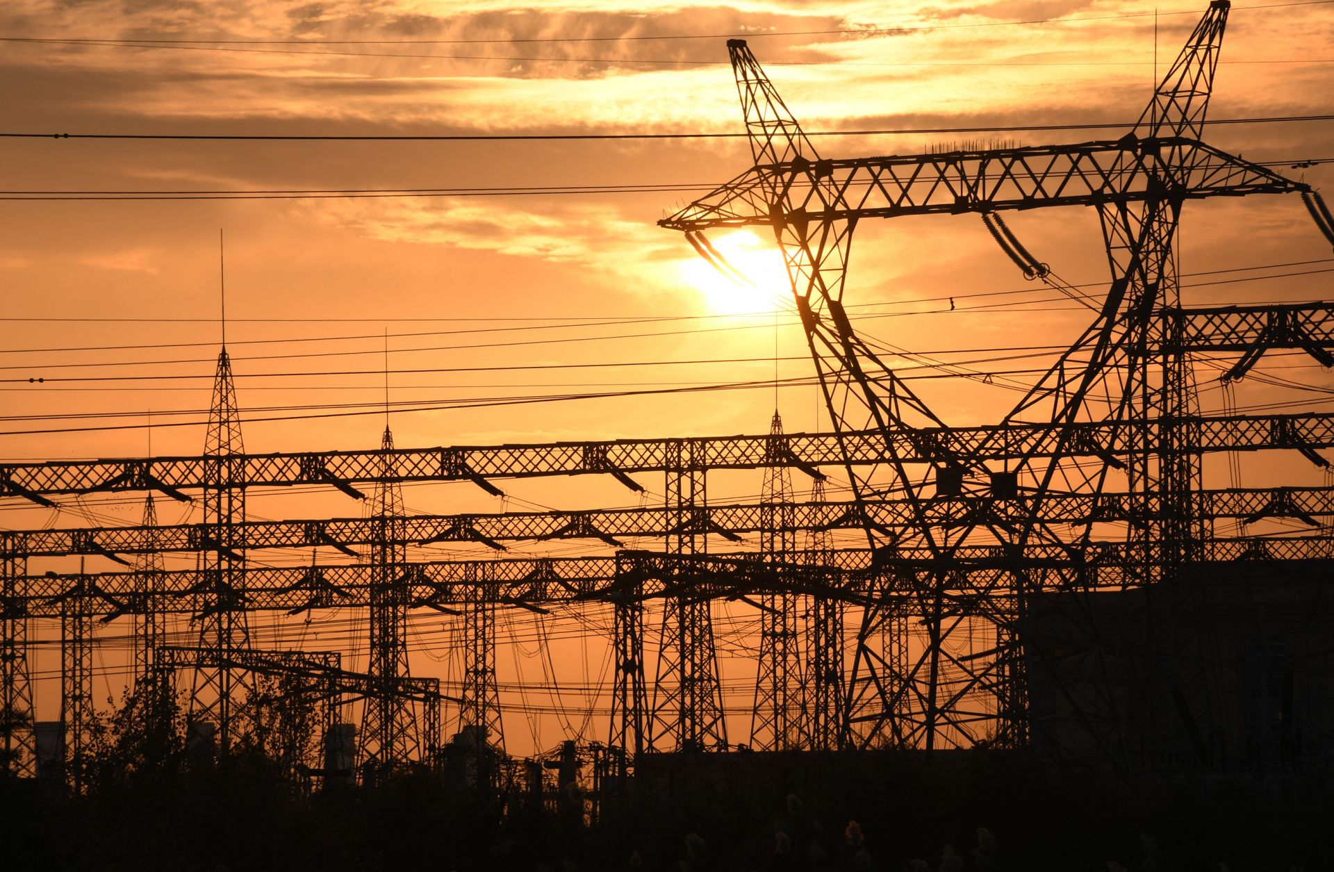 The sun sets behind electrical grids in the southern Iraqi city of Nasiriyah on Jan. 3, 2021. 