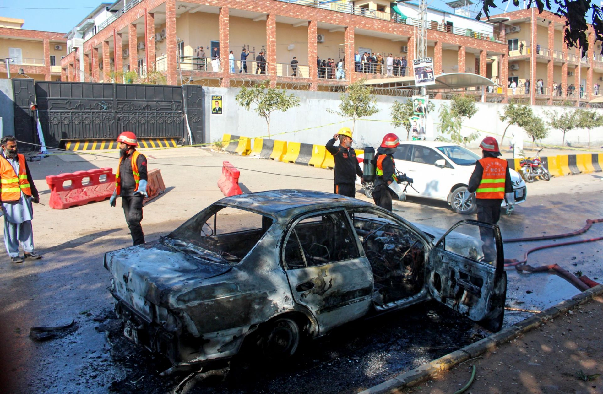 Firefighters douse a car at the suicide blast site in Islamabad, Pakistan, on Nov. 11, 2025. 