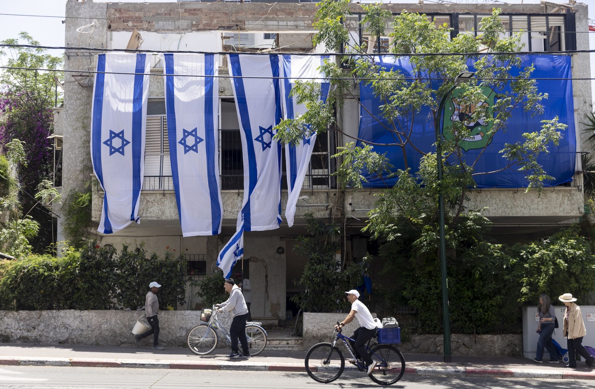 People pass by a building in Ramat Gan, Israel, that was destroyed by an Iranian ballistic missile on May 5, 2026. People pass by a building in Ramat Gan, Israel, that was destroyed by an Iranian ballistic missile on May 5, 2026.