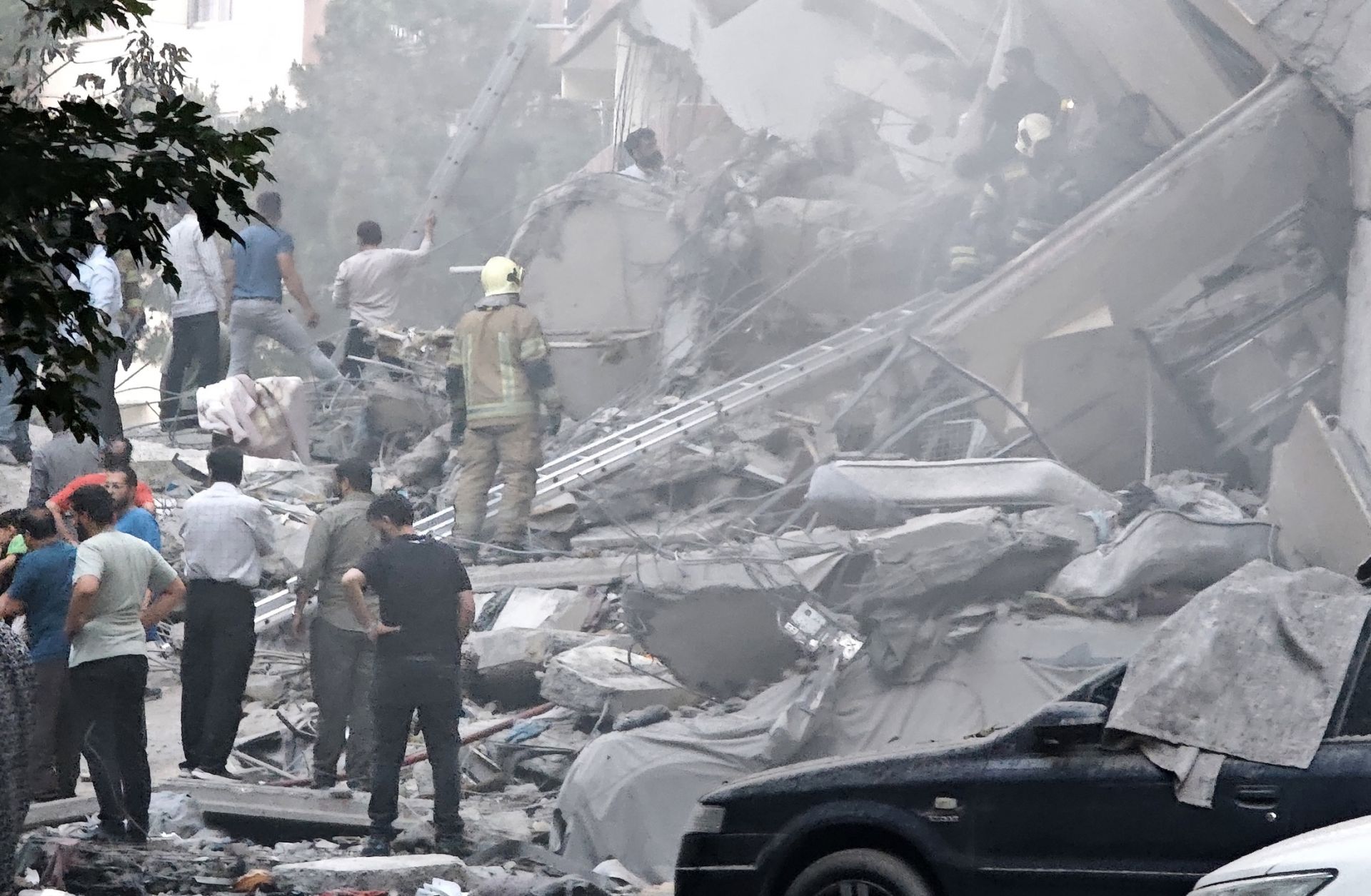 Rescue teams work at damaged buildings in Nobonyad Square following Israeli airstrikes on June 13, 2025, in Tehran, Iran. 