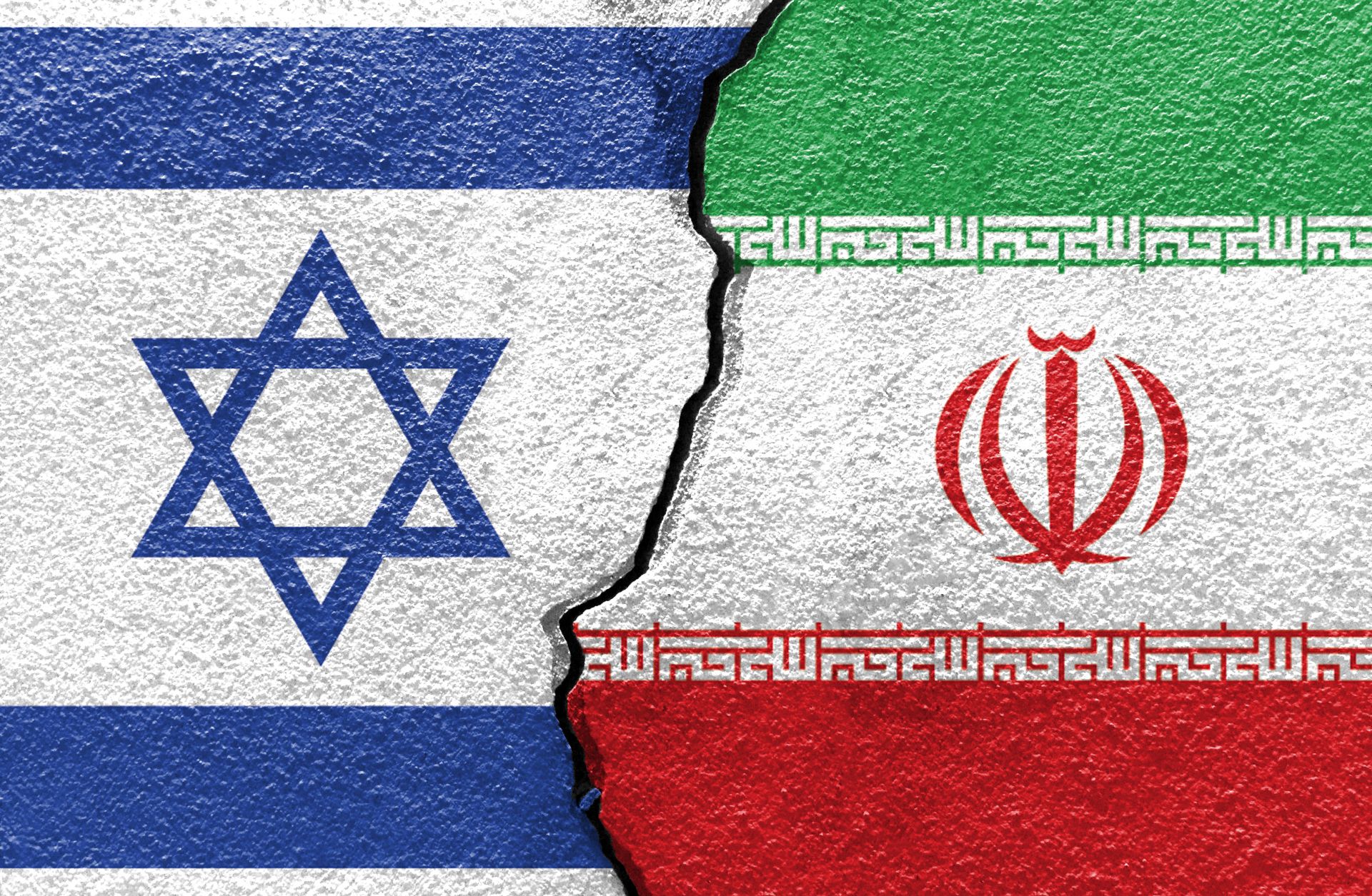 An illustration shows the flags of Israel and Iran painted on a cracked wall. An illustration shows the flags of Israel and Iran painted on a cracked wall.