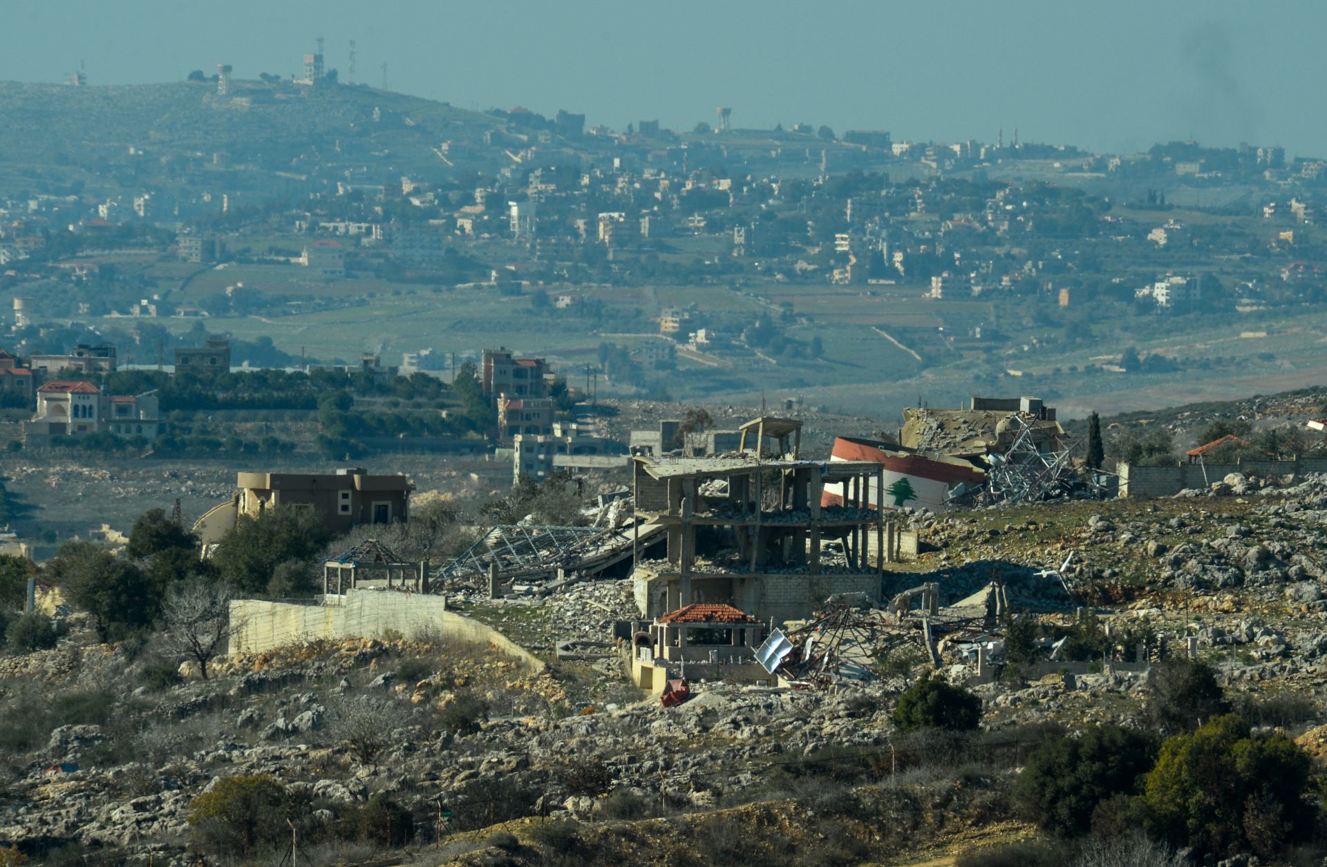 A collapsed water tank painted with the Lebanese flag is seen in the ruins of a village in southern Lebanon, located near the border with Israel, on Jan. 7, 2025.