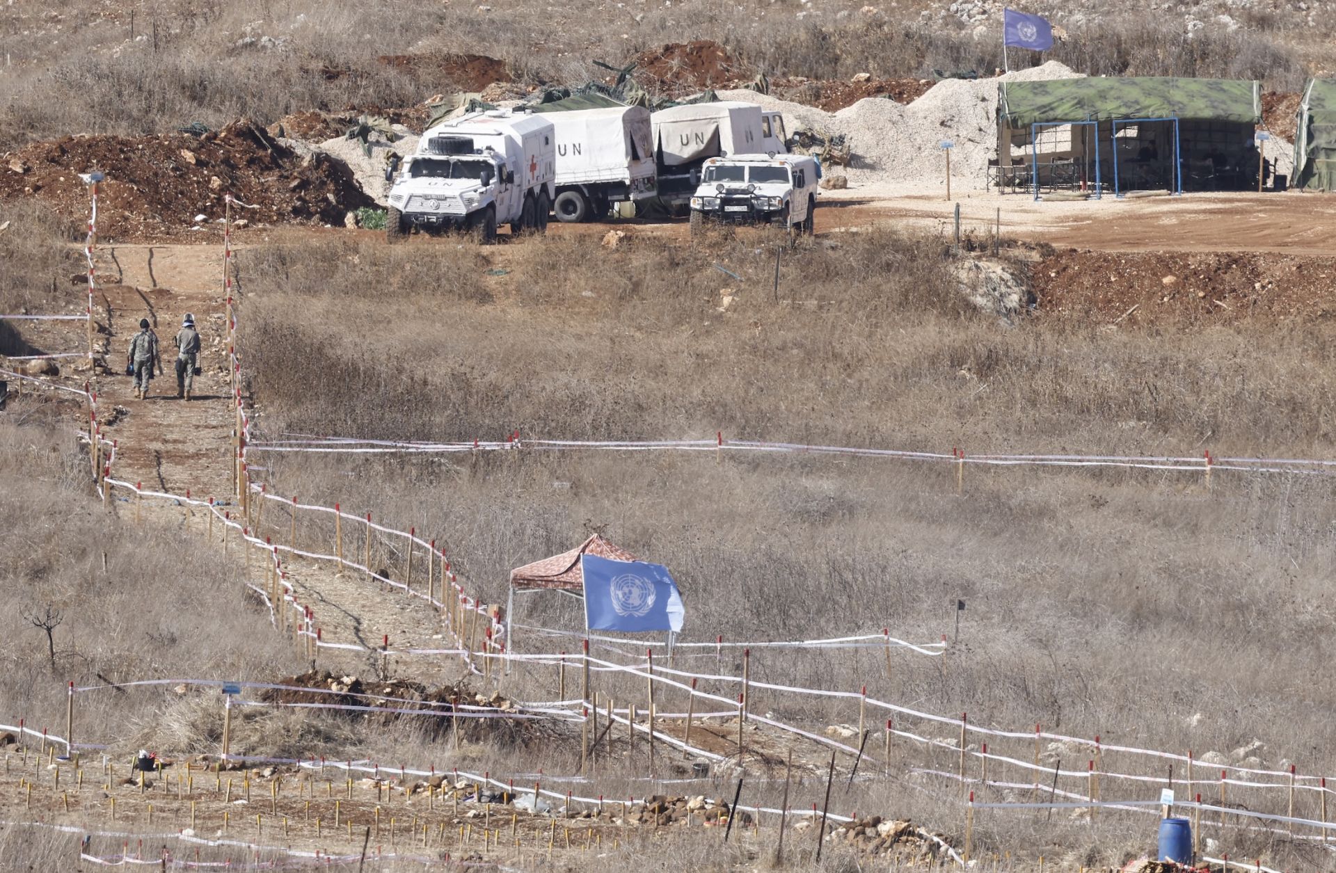 A photograph taken from the Israeli side of the border with southern Lebanon shows U.N. peacekeepers clearing landmines on Nov. 19, 2025. 