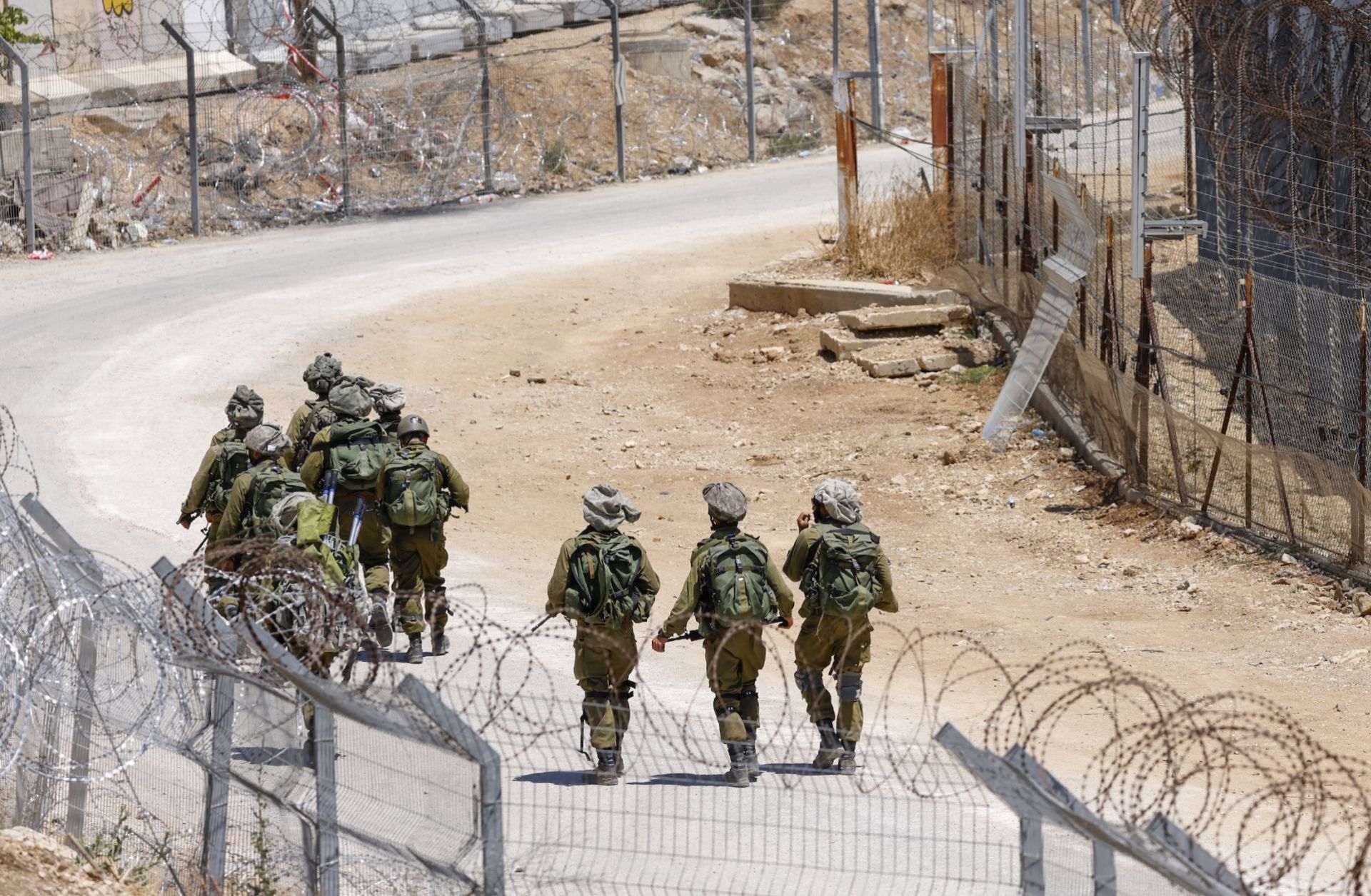 Israeli troops patrol the border fence with Syria near the Druze village of Majdal Shams in the Israel-annexed Golan Heights on July 23, 2025. 