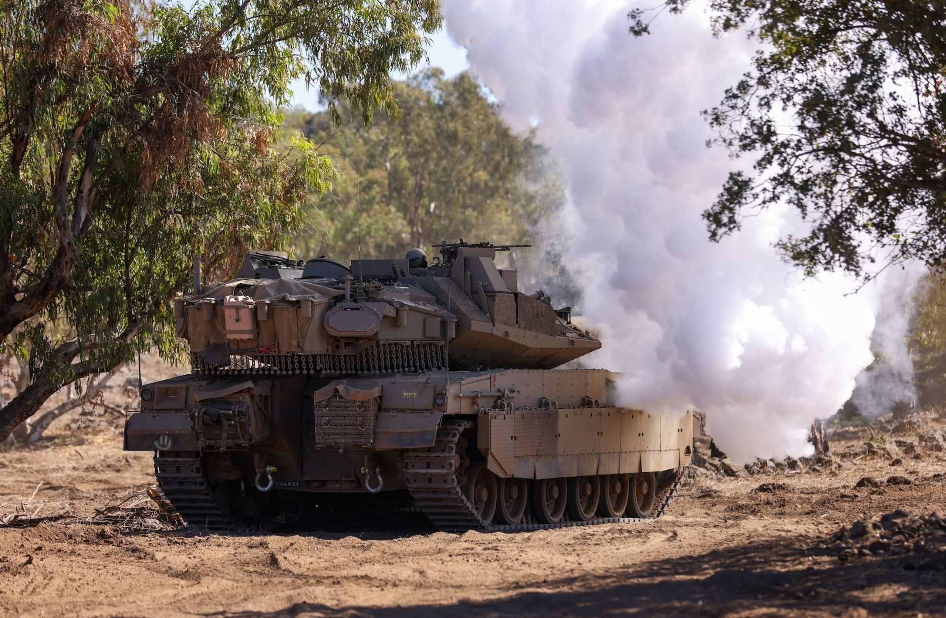 An Israeli tank moves into position during a drill in the annexed Golan Heights on Nov. 9, 2023, amid increasing cross-border tensions between Hezbollah and Israel as fighting continues in Israel's south with Hamas militants in the Gaza Strip.