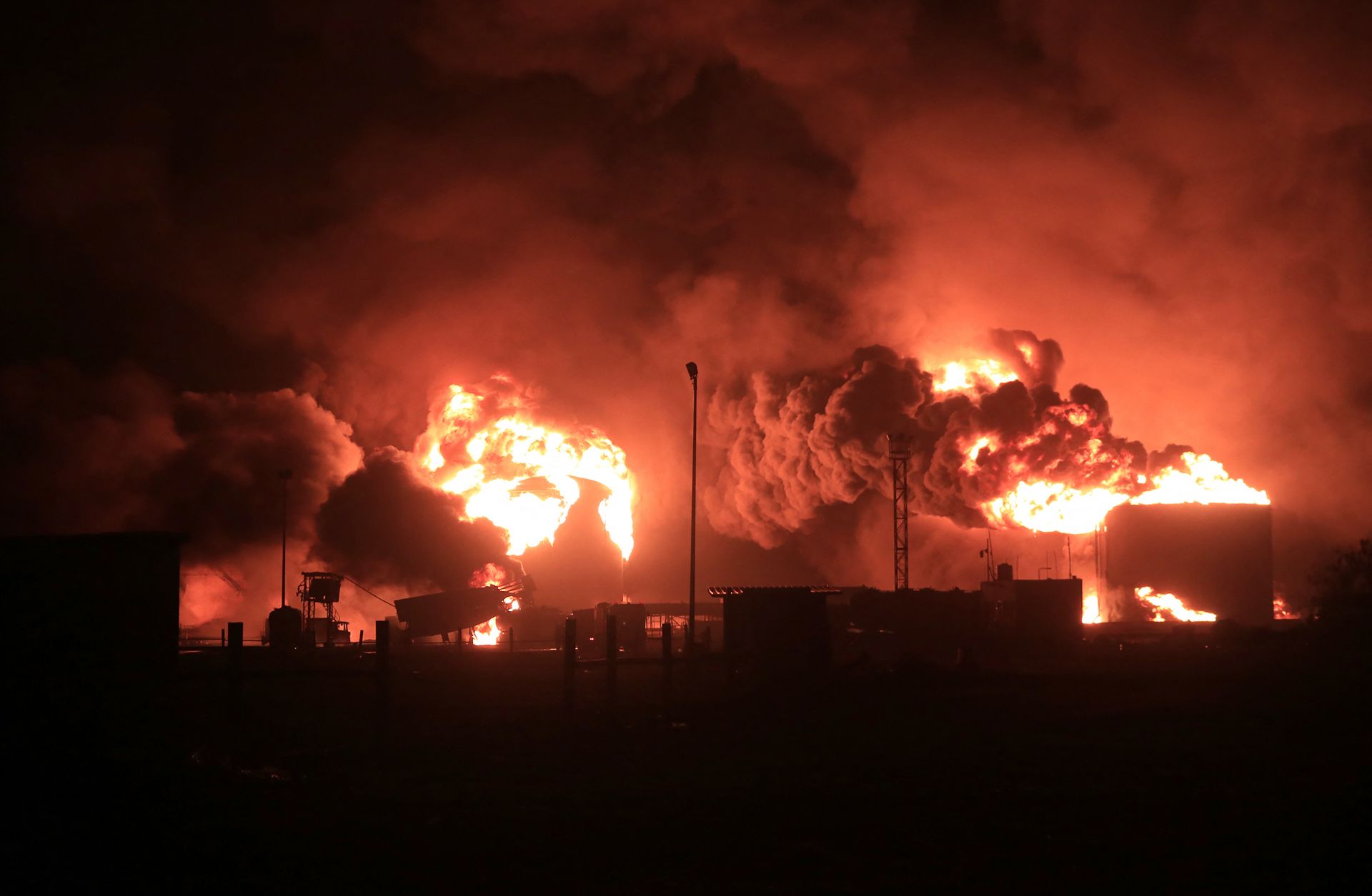 A giant fire erupts at an oil storage facility following Israeli strikes in Yemen's Houthi-held port city of Hodeida on July 20, 2024. 