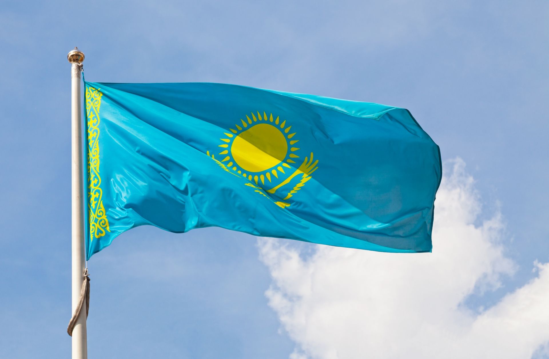 The national flag of Kazakhstan waves in the wind. The national flag of Kazakhstan waves in the wind.