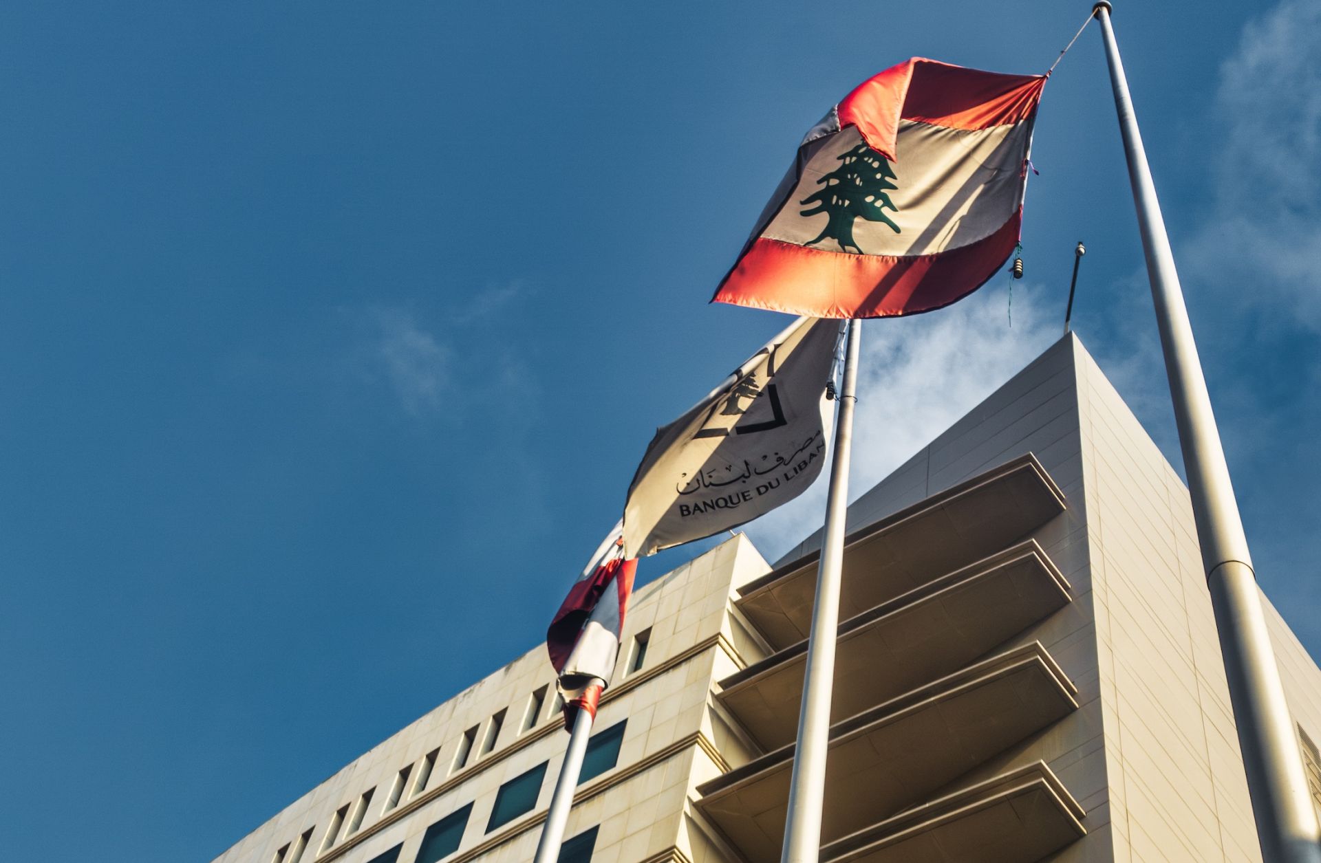 Lebanese flags fly outside of Lebanon's central bank in July 2023.