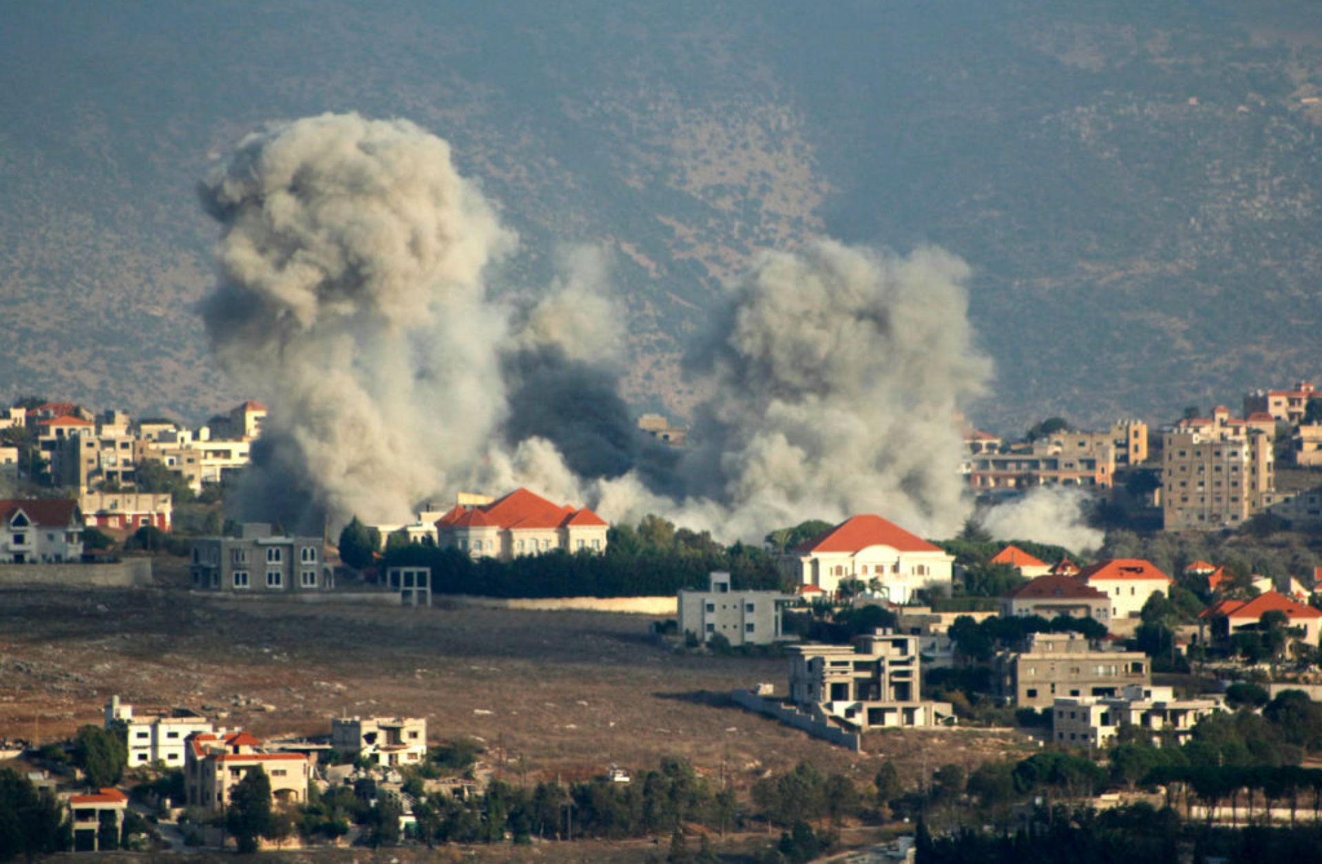 A plume of smoke billows following an Israeli air strike above a border town in southern Lebanon on Oct. 7, 2024. 