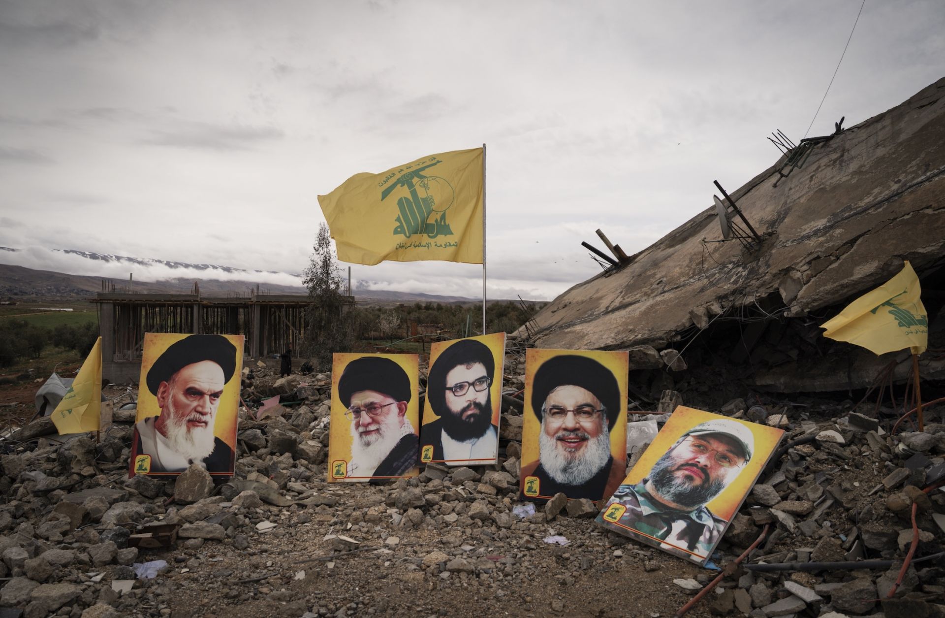 Photos of prominent Hezbollah leaders are seen at the site of a reported Israeli airstrike which killed 6 members of the same family, on March 19, 2026 in Baalbek, Lebanon.