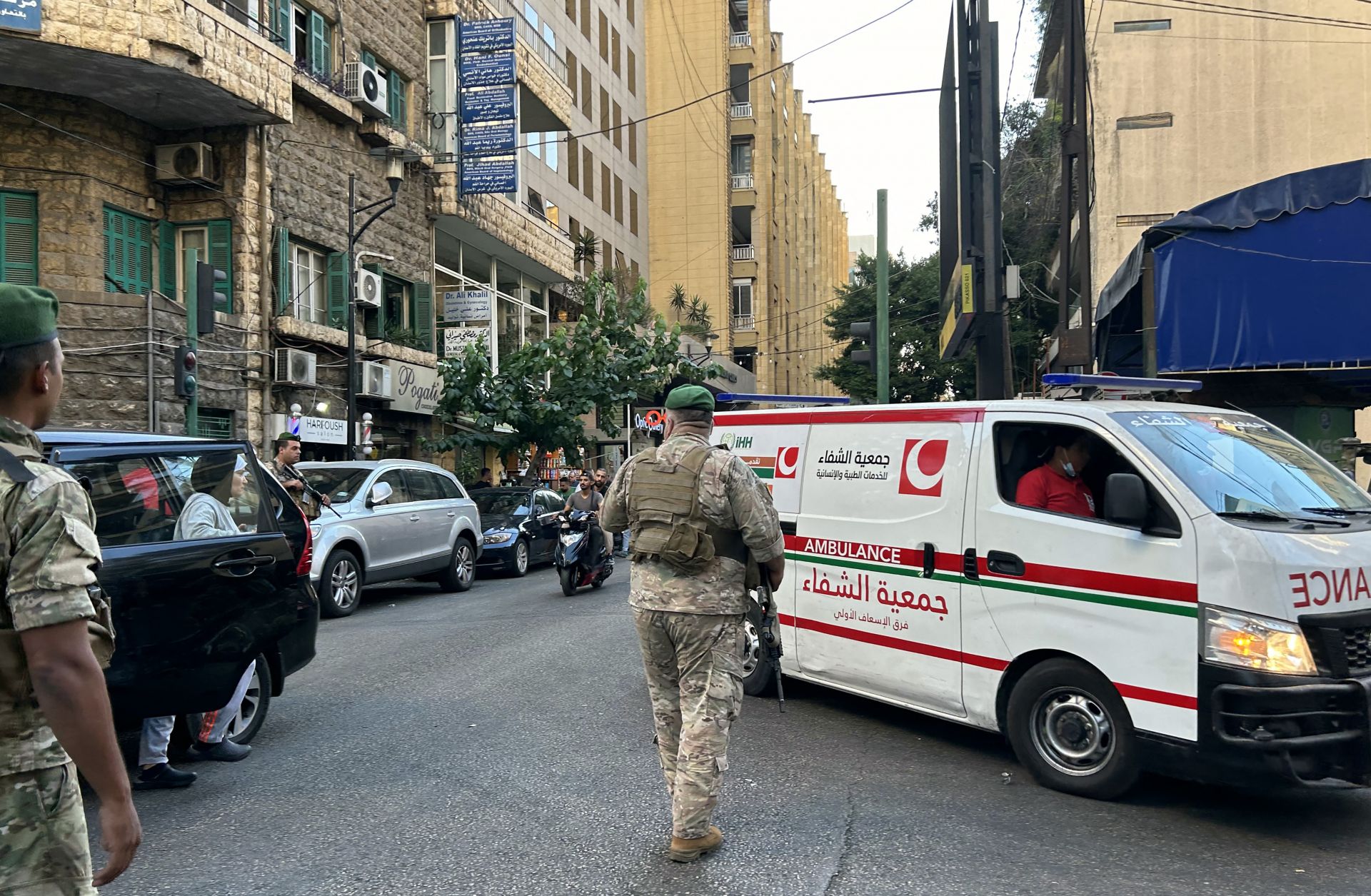 Lebanese soldiers stand guard as an ambulance rushes wounded people to a hospital in Beirut on Sept. 17, 2024, after explosions hit locations in several Hezbollah strongholds around Lebanon amid ongoing cross-border tensions between Israel and Hezbollah fighters.