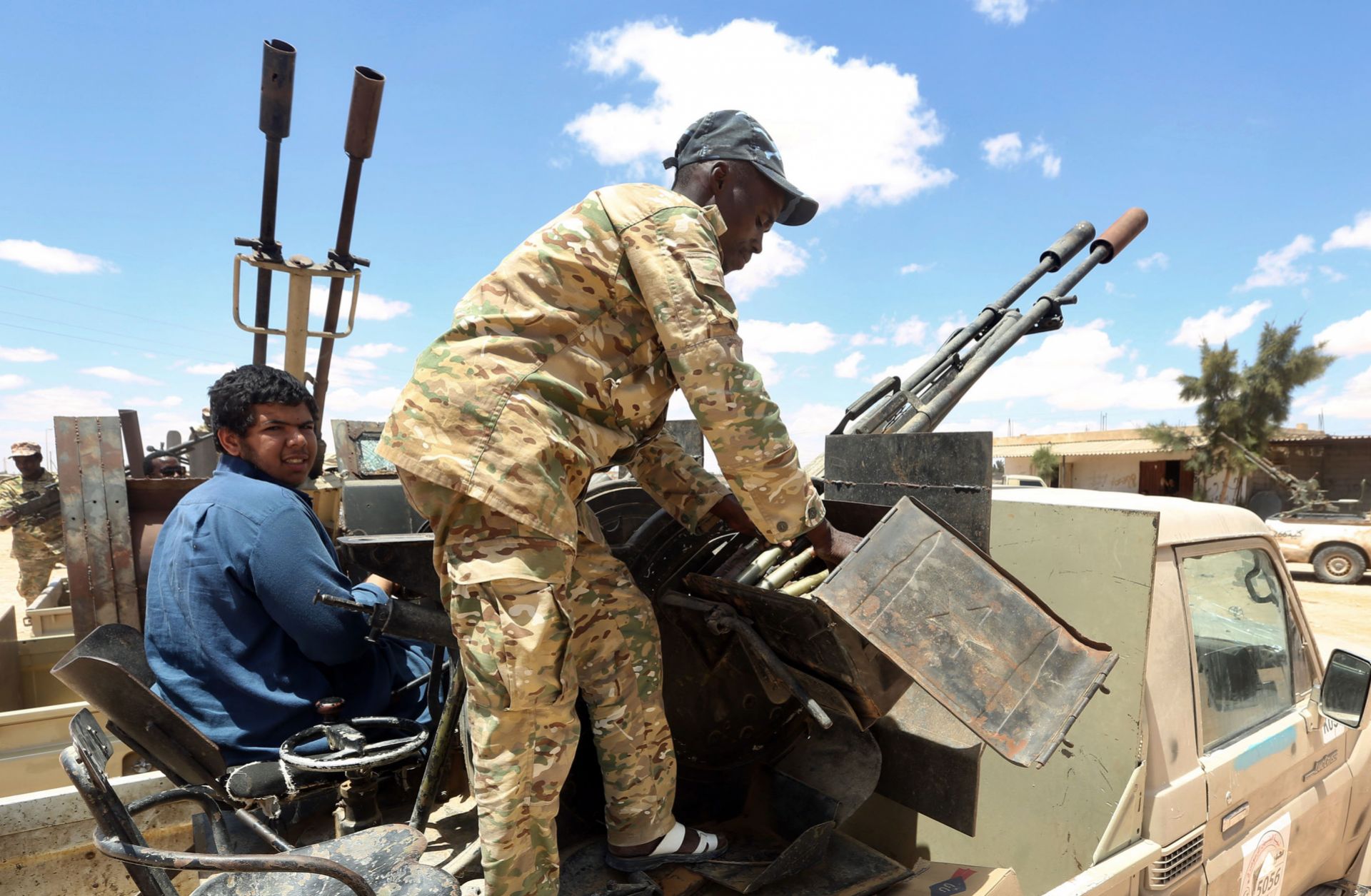 Fighters aligned with Libya's internationally-recognized Government of National Accord (GNA) patrol a village located halfway between Tripoli and Benghazi on July 20, 2020.
