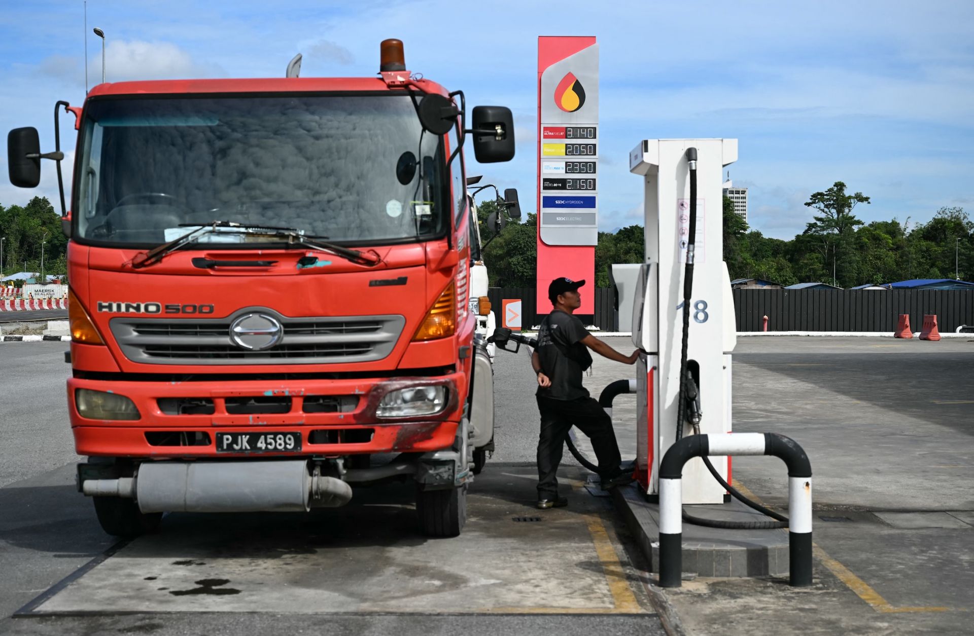 A man fills up his truck at a Petroleum Sarawak Berhad (Petros) station in Kuching, Malaysia, on June 20, 2025.