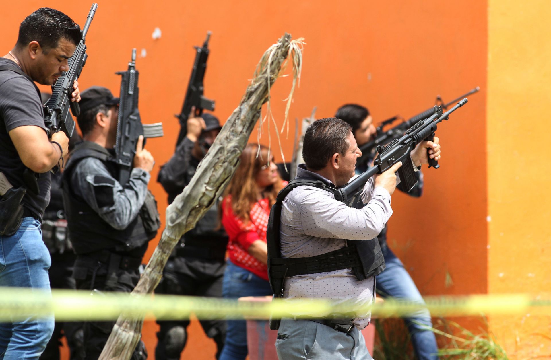 Mexican police take position outside a house during a search in Tlajomulco de Zuniga, Jalisco State, Mexico, on June 21, 2019.