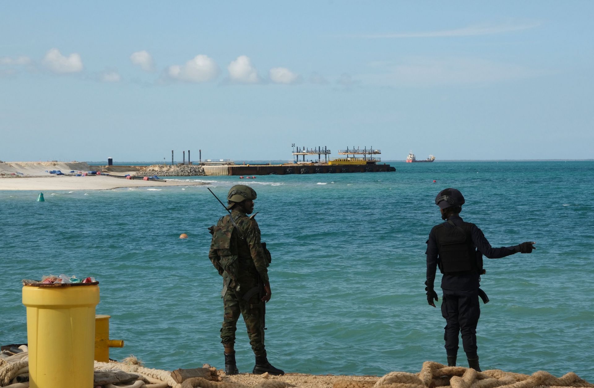 A Rwandan policeman (R) and a Rwandan soldier (L) guard TotalEnergies' Mozambique LNG project in Cabo Delgado province, Mozambique, on Sept. 29, 2022.
