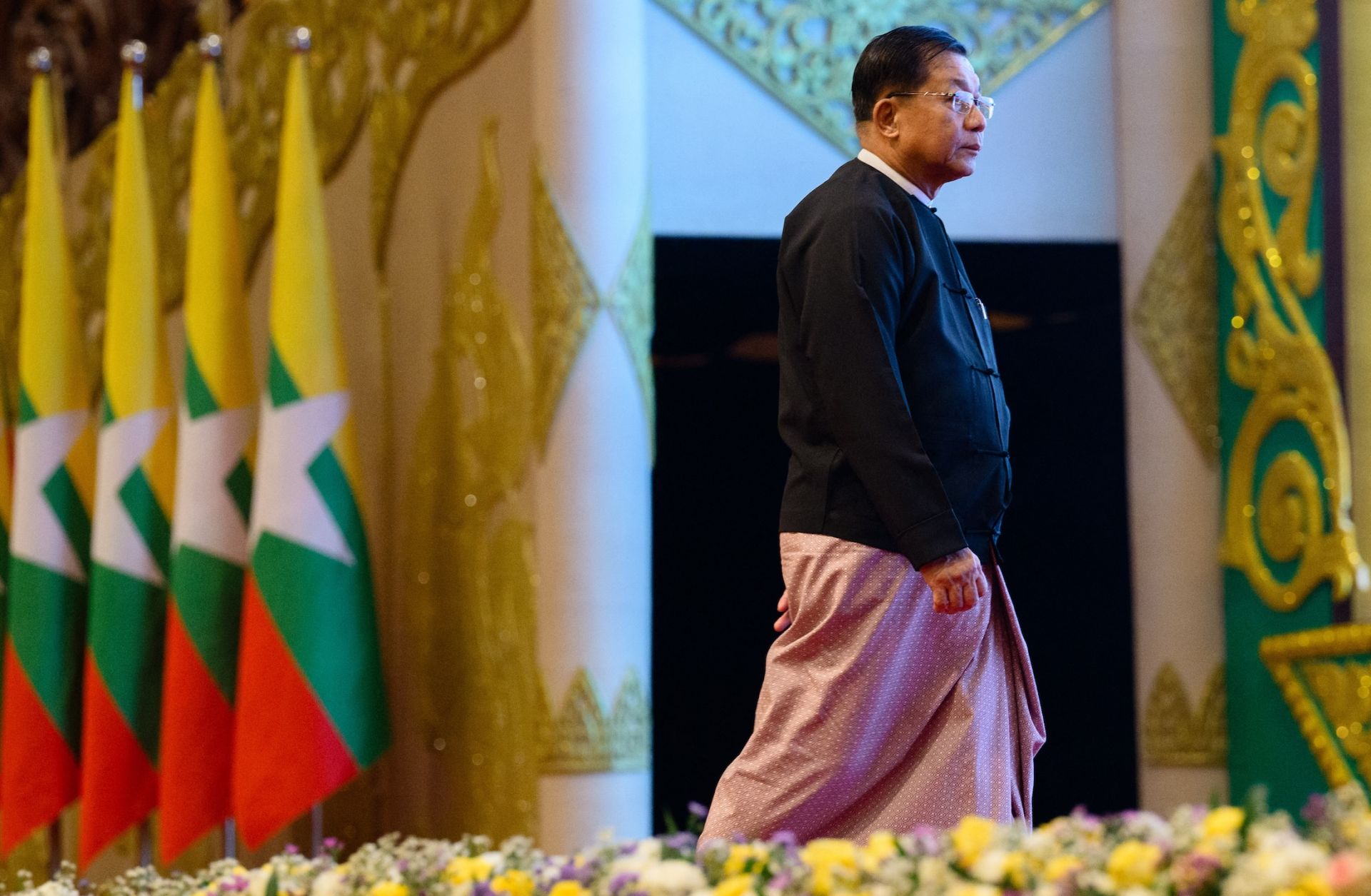 Myanmar's then-military chief Min Aung Hlaing prepares to deliver a speech during a memorial event at the Myanmar International Convention Center in Naypyidaw on March 28, 2026, to mark the first anniversary since a 7.7-magnitude tremor killed more than 3,800 people in Myanmar.