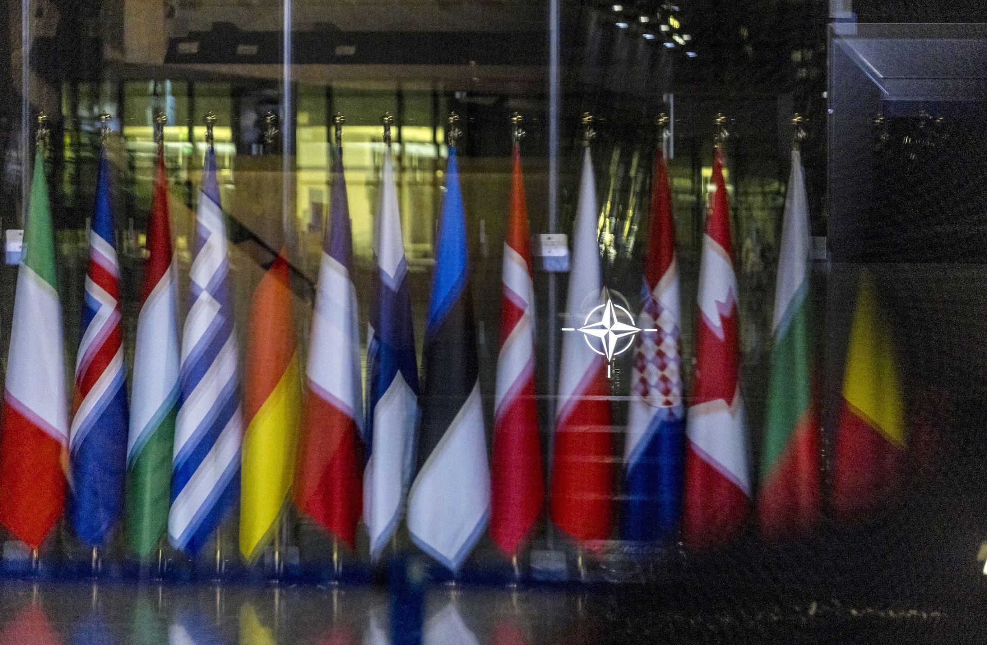The NATO symbol and flags of some member countries Oct. 18 in Brussels.