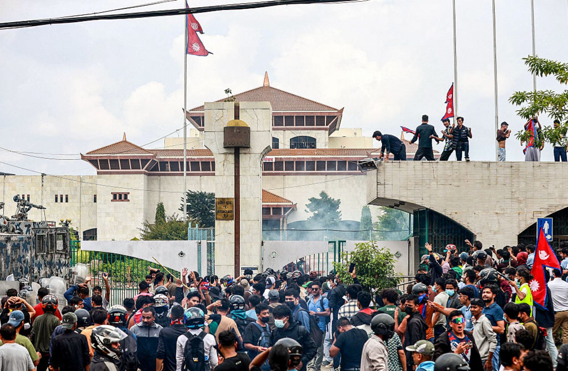 Demonstrators carrying Nepal's national flag stage a protest outside the parliament building in Kathmandu on Sept. 8, 2025, against social media prohibitions and government corruption. 