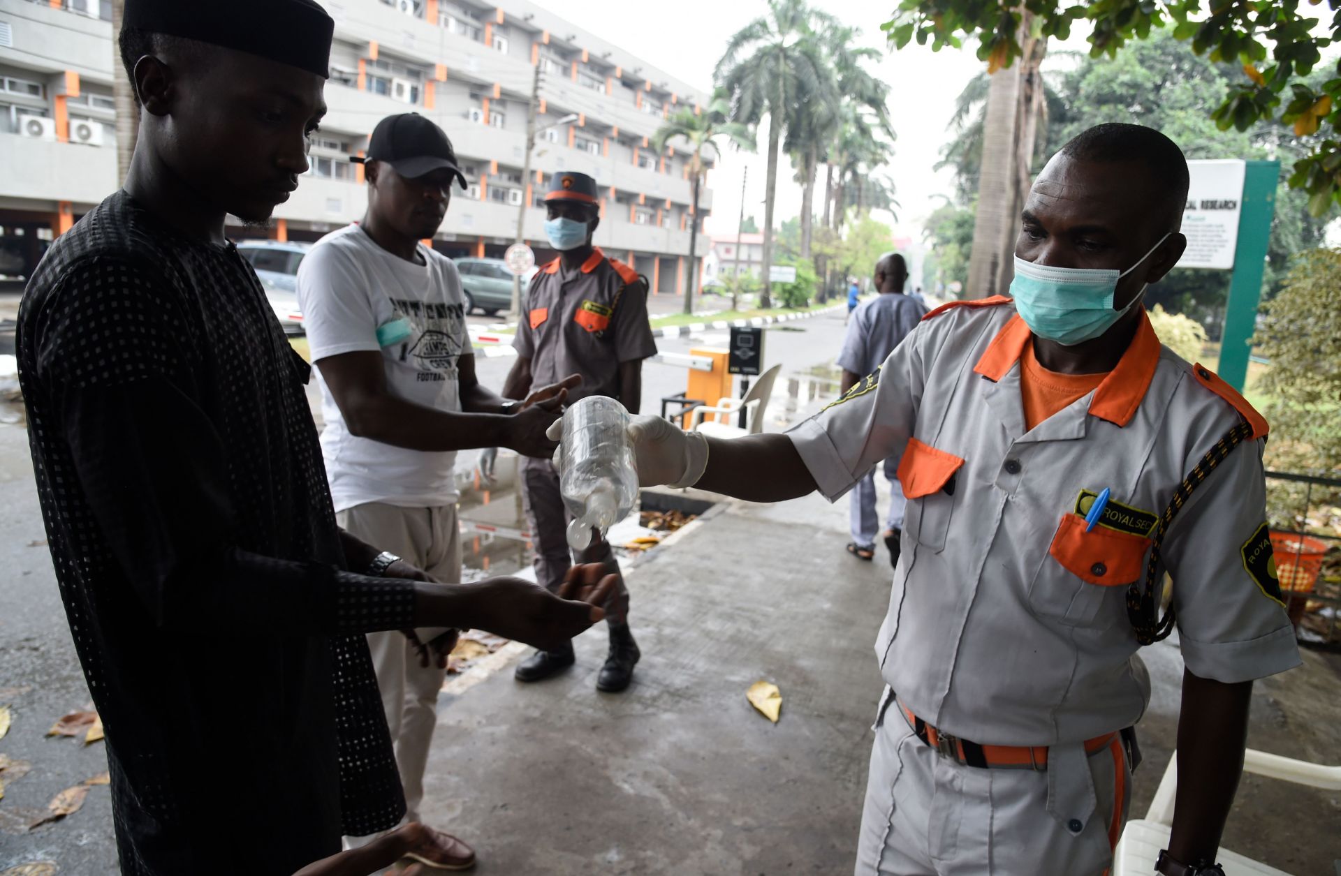 A photo of a security official administers hand sanitizer in Lagos, Nigeria, on Feb. 28, 2020. The city's 20 million residents scrambled for hygiene products following the announcement of the first confirmed coronavirus case in sub-Saharan Africa.