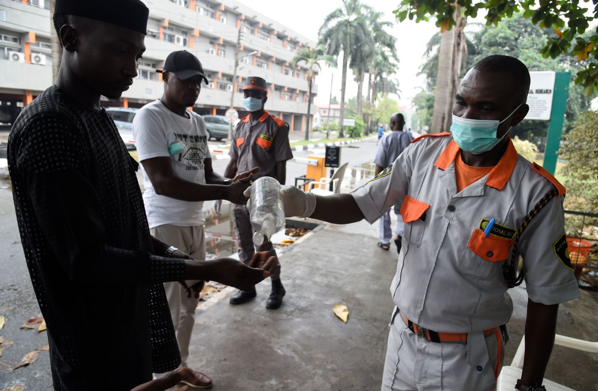A security official administers hand sanitizer in Nigeria. A photo of a security official administers hand sanitizer in Lagos, Nigeria, on Feb. 28, 2020. The city's 20 million residents scrambled for hygiene products following the announcement of the first confirmed coronavirus case in sub-Saharan Africa.