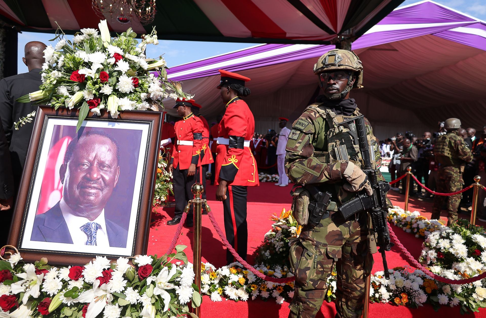 Kenyan forces stand next to the coffin of former Prime Minister Raila Odinga during a funeral mass at Jaramogi Oginga Odinga University of Science and Technology on October 19, 2025 in Bondo, Kenya.
