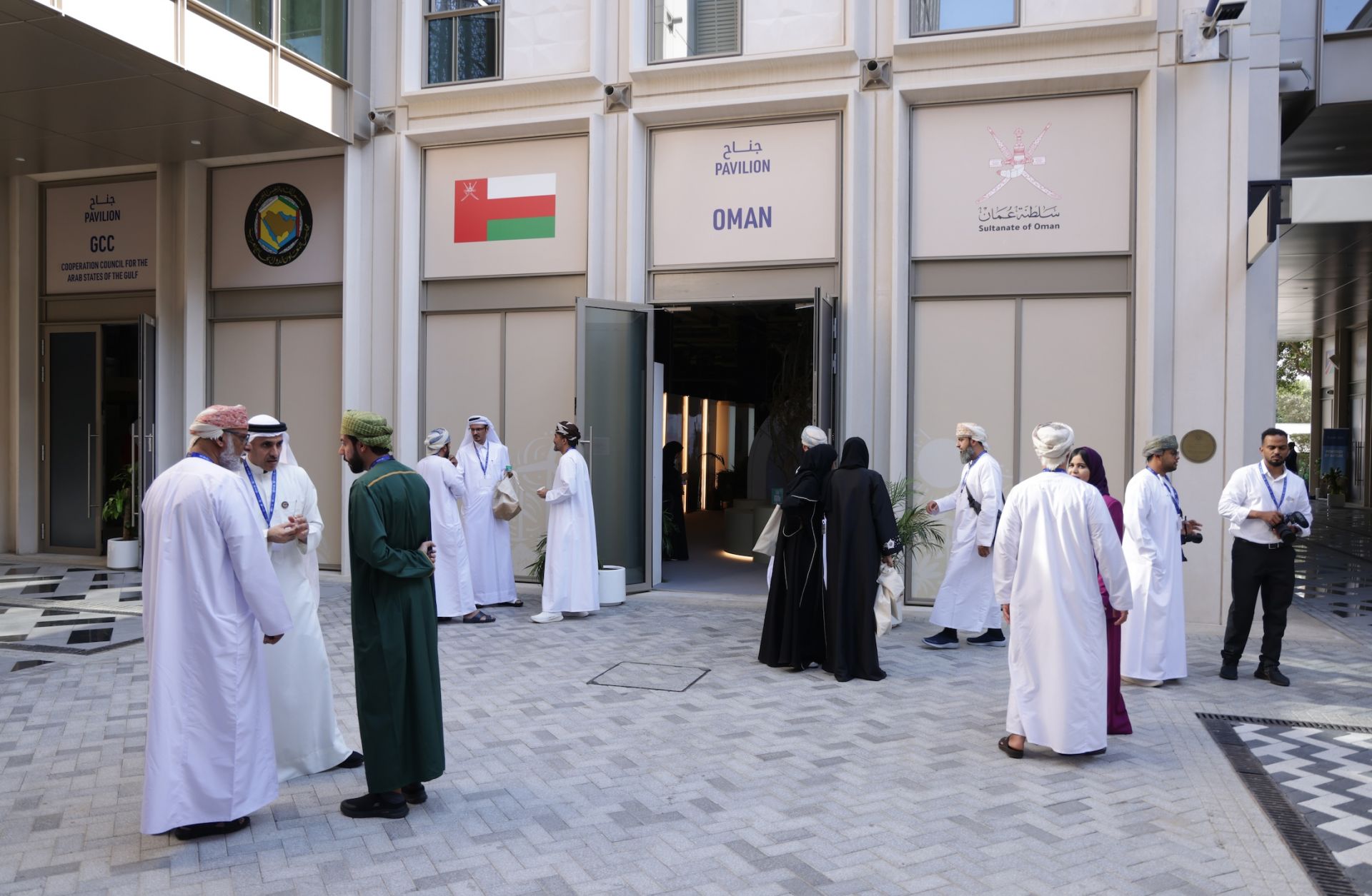 Participants stand outside the pavilion of Oman as they attend day nine of the U.N. Climate Change Conference in Dubai, United Arab Emirates, on Dec. 9, 2023. 