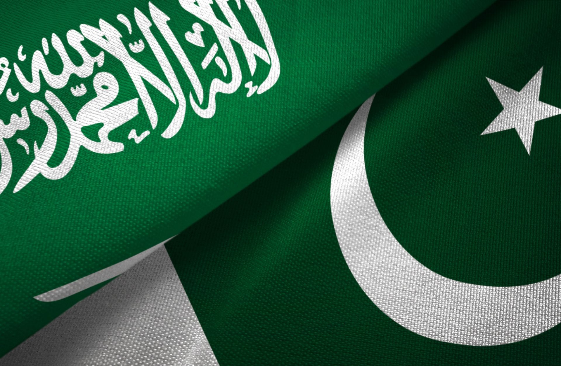 A digital illustration of Pakistan and Saudi Arabia’s national flags.