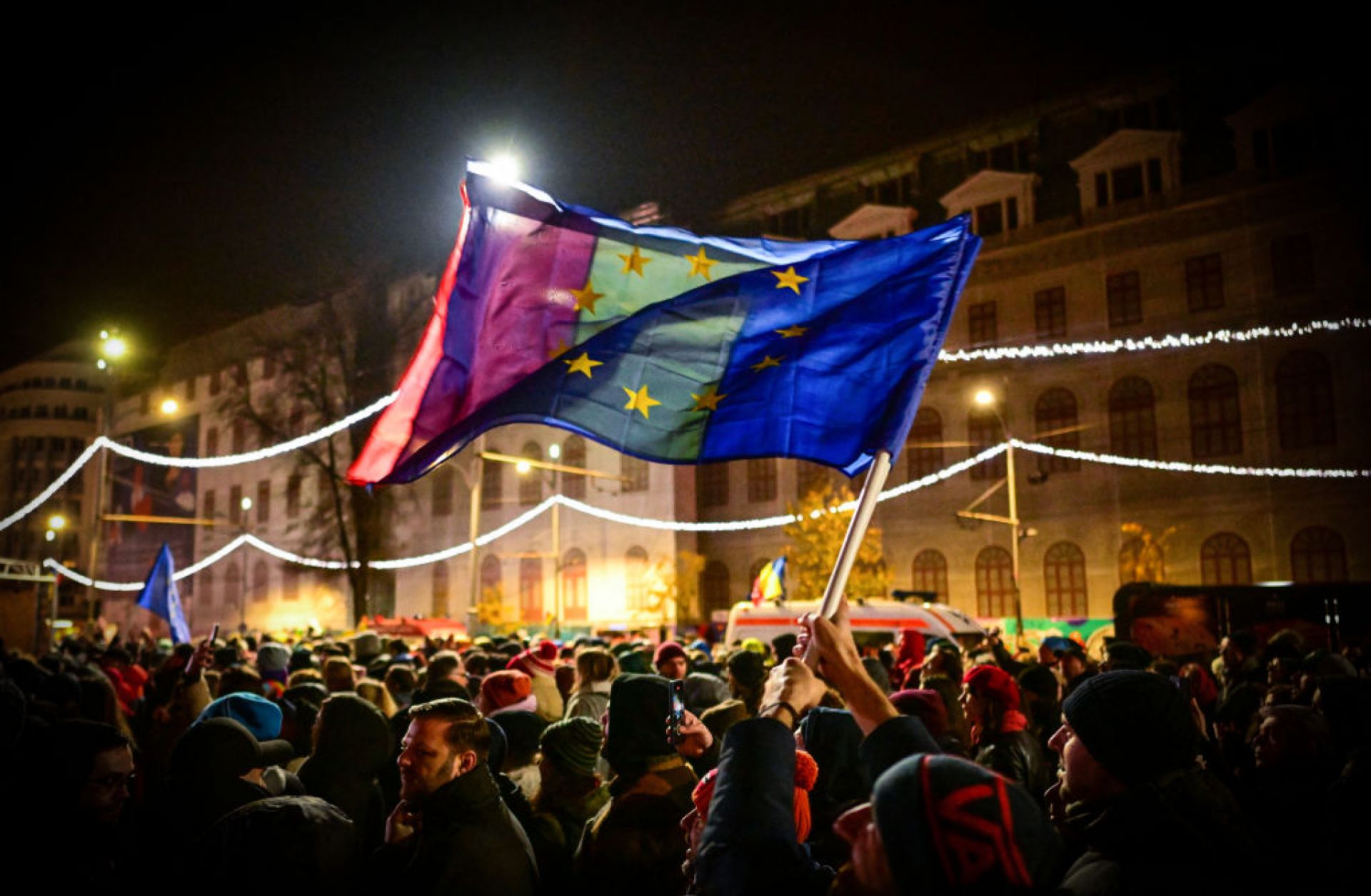 Demonstrators hold EU and Romanian national flags during a pro-European rally in support of democracy at University Square in Bucharest, Romania, on Dec. 5, 2024, a few days before key elections. 