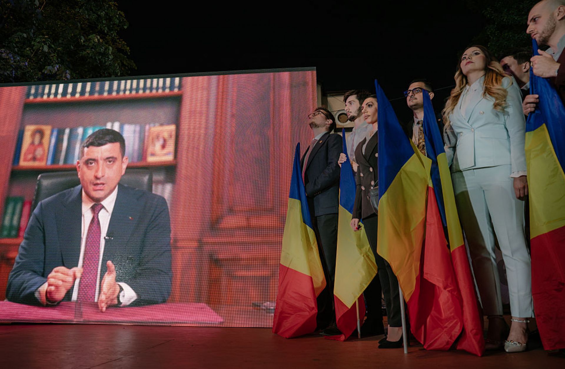 Presidential candidate George Simion is shown on a screen addressing his supporters at the campaign headquarters of their candidate after polls closed on May 4, 2025 in Bucharest, Romania.