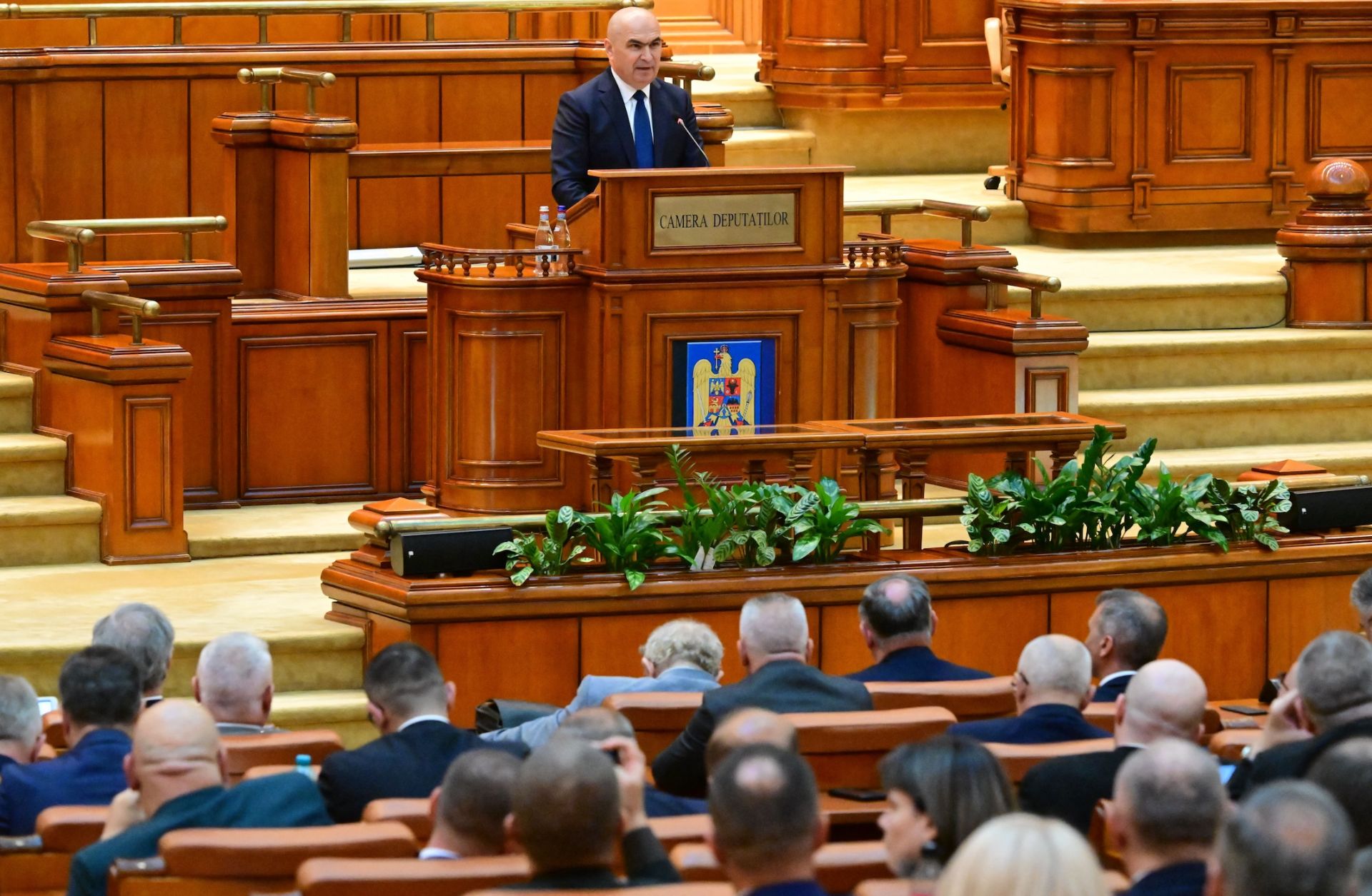 Romanian Prime Minister Ilie Bolojan delivers a speech to lawmakers in parliament in Bucharest on June 23, 2025.