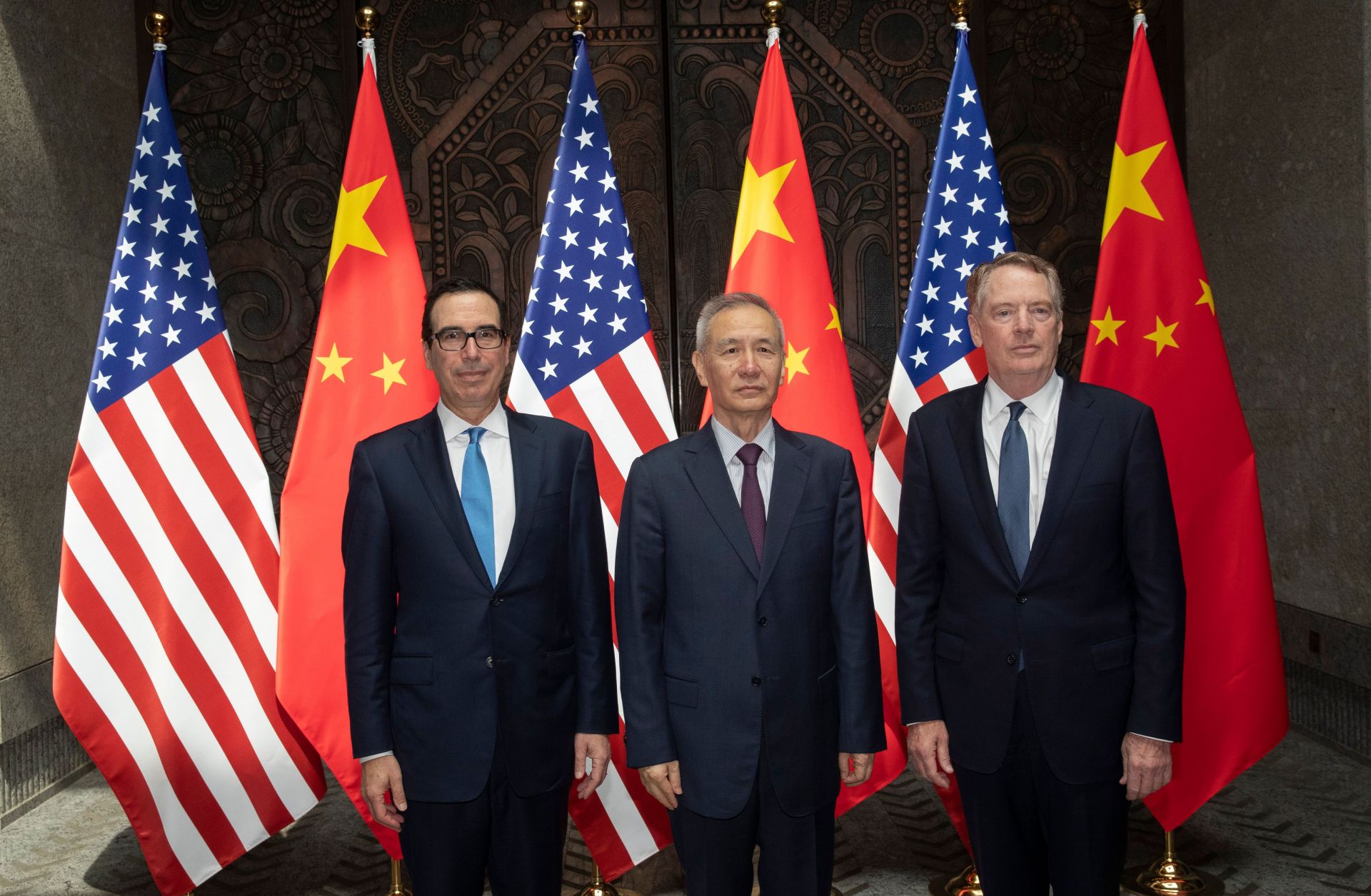 U.S. Treasury Secretary Steven Mnuchin (left) and U.S. Trade Representative Robert Lighthizer flank Chinese Vice Premier Liu He as they pose for photographs before holding trade talks in Shanghai on July 31, 2019.