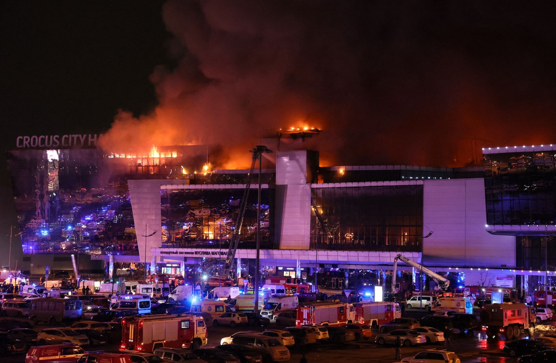 Emergency services vehicles are seen outside the burning Crocus City Hall concert hall following a shooting incident in Krasnogorsk, outside Moscow, Russia, on March 22, 2024. 