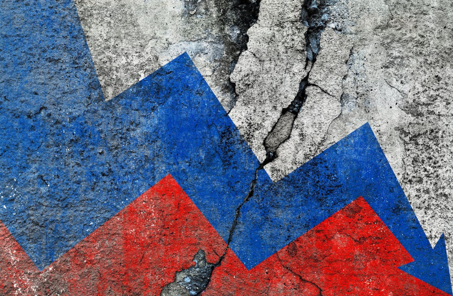 Russian flag on a cracked wall, illustrating an economic decline with a downward arrow. 