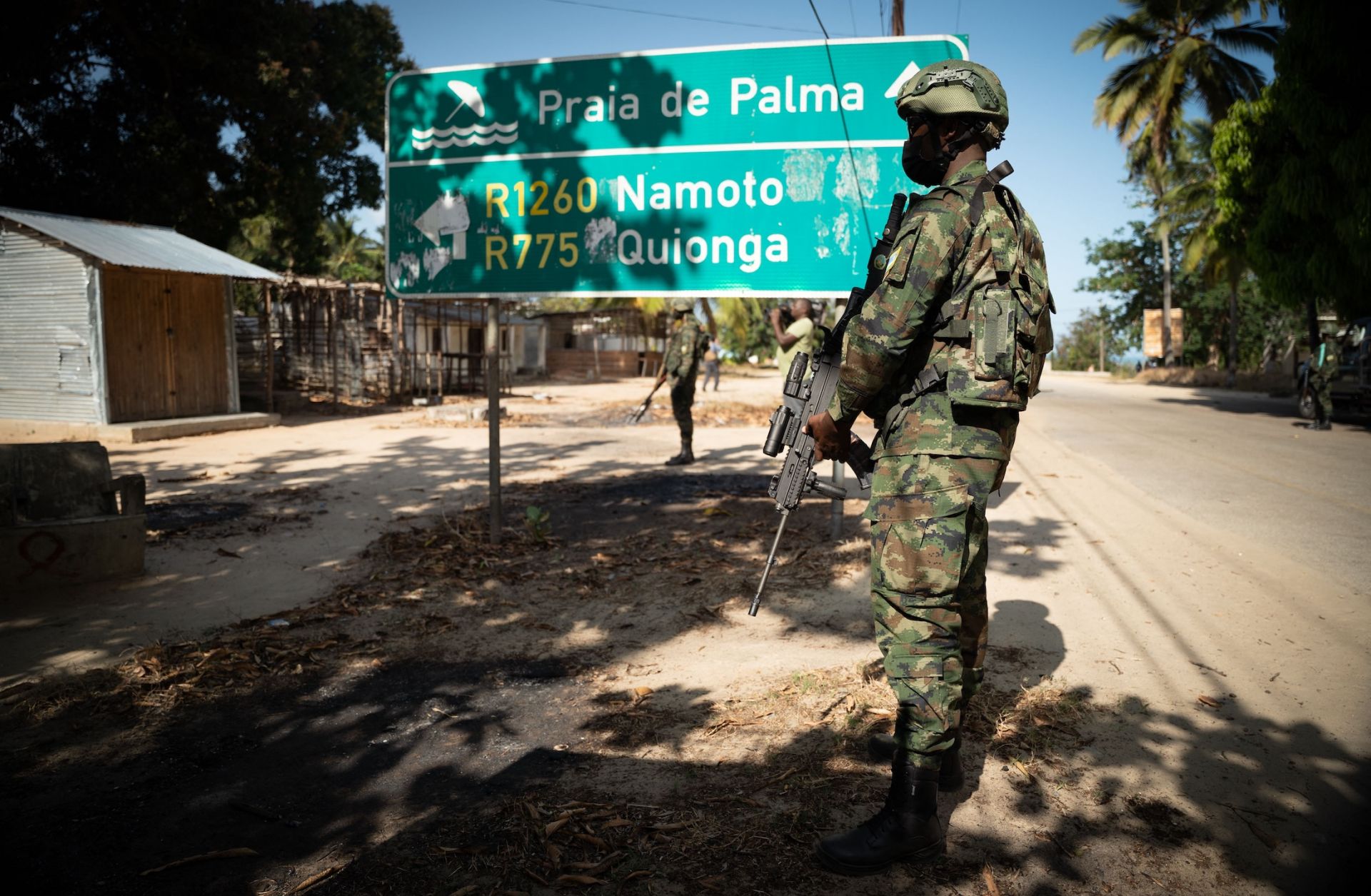 A Rwandan soldier walks in front of a burned truck near Palma in Mozambique’s Cabo Delgado region on Sept. 22, 2021. 