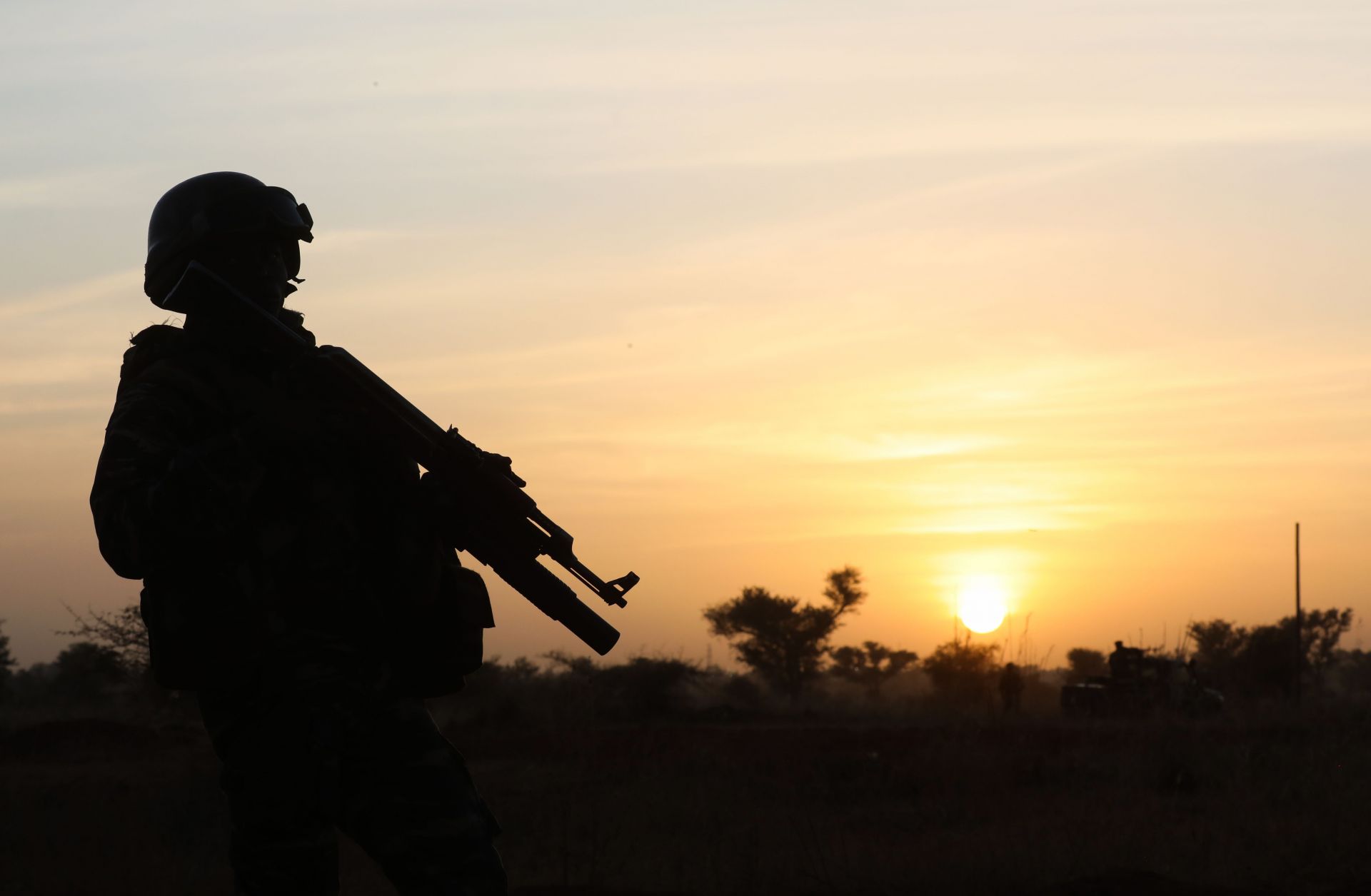 This photo shows the outline of a soldier standing guard at sunset in Niamey, Niger, on Dec. 22, 2019.