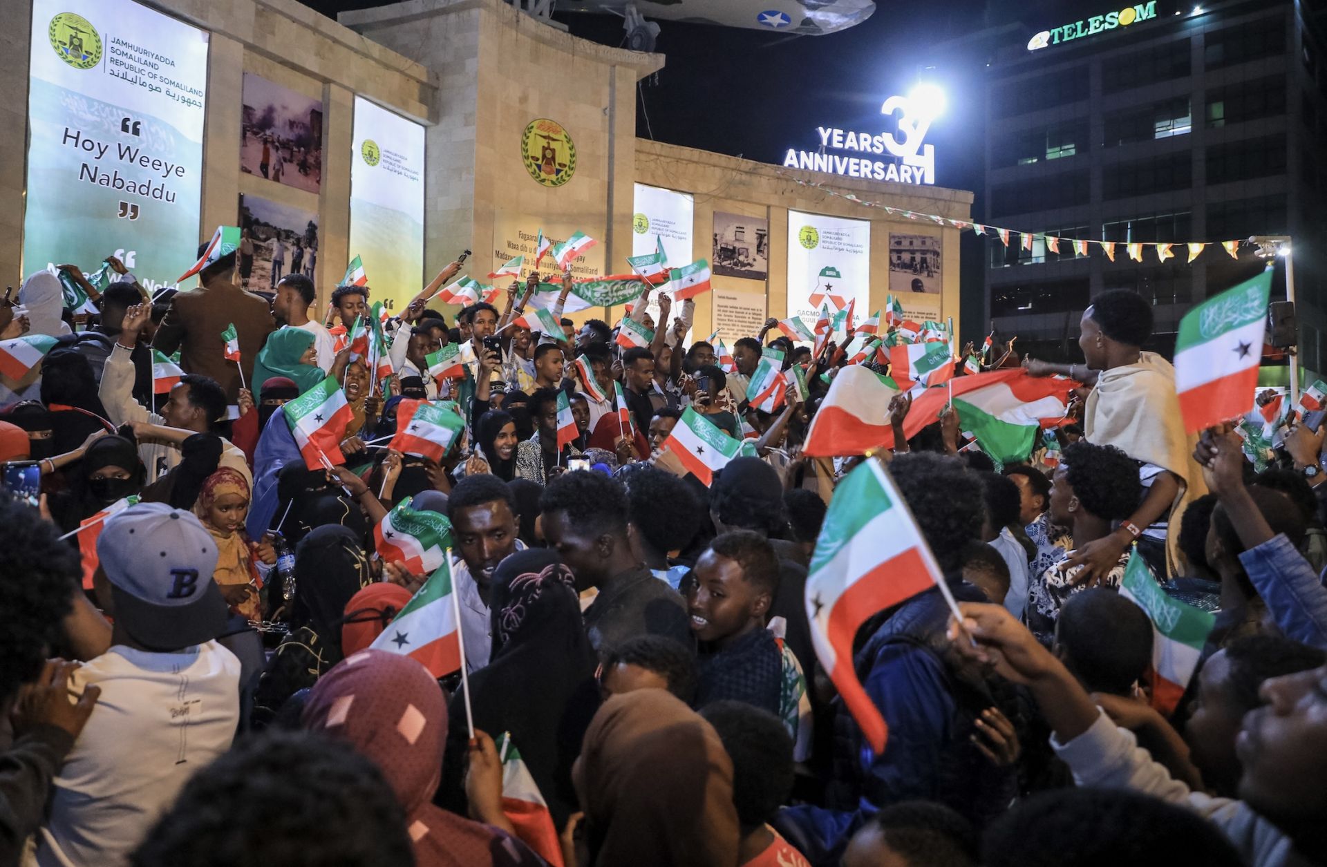 Residents wave Somaliland flags as they gather to celebrate Israel's announcement recognizing Somaliland's statehood in downtown Hargeisa, on Dec. 26, 2025. 