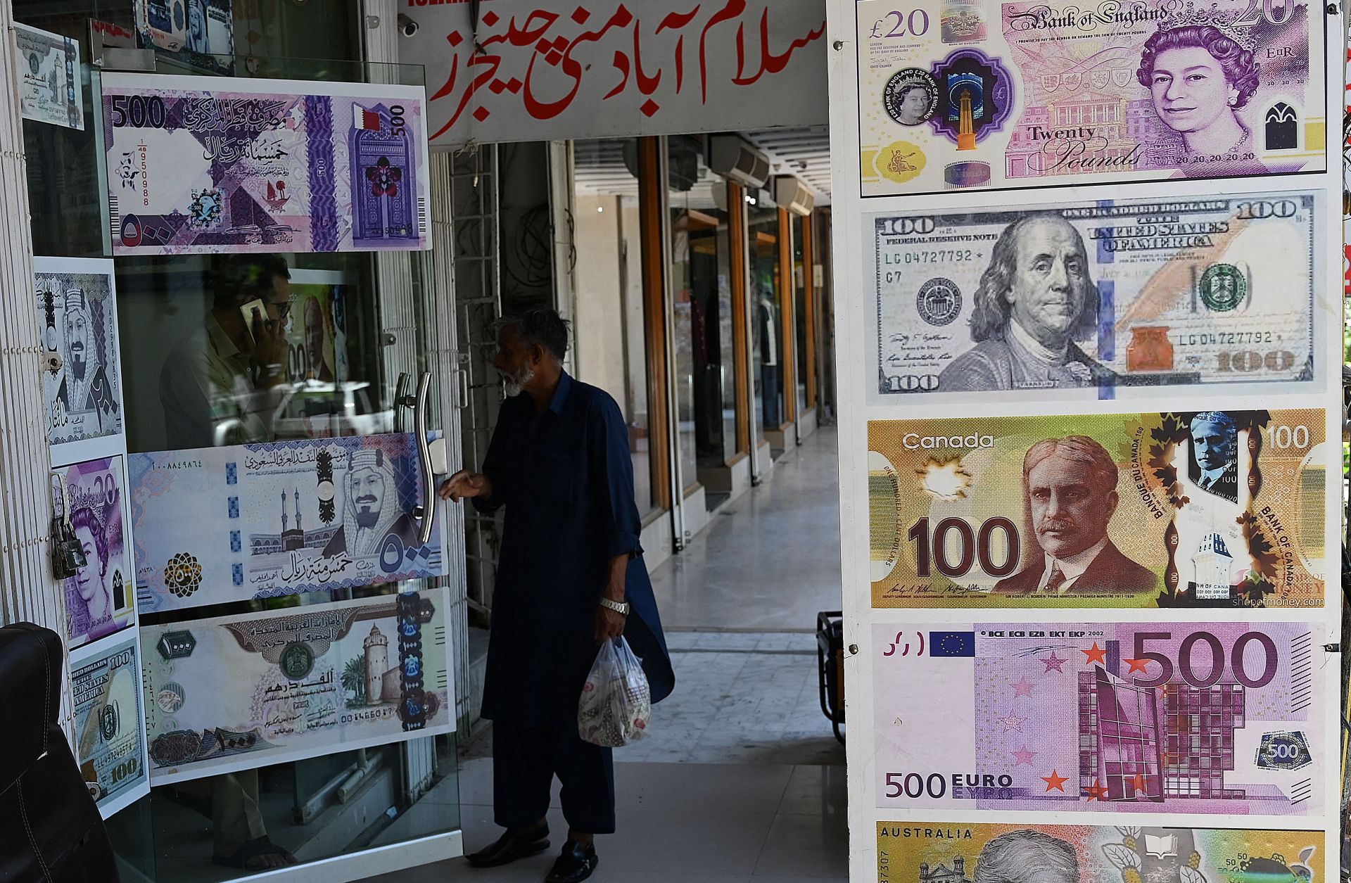 A man enters a foreign currency exchange shop in Islamabad, Pakistan, on July 11, 2023.