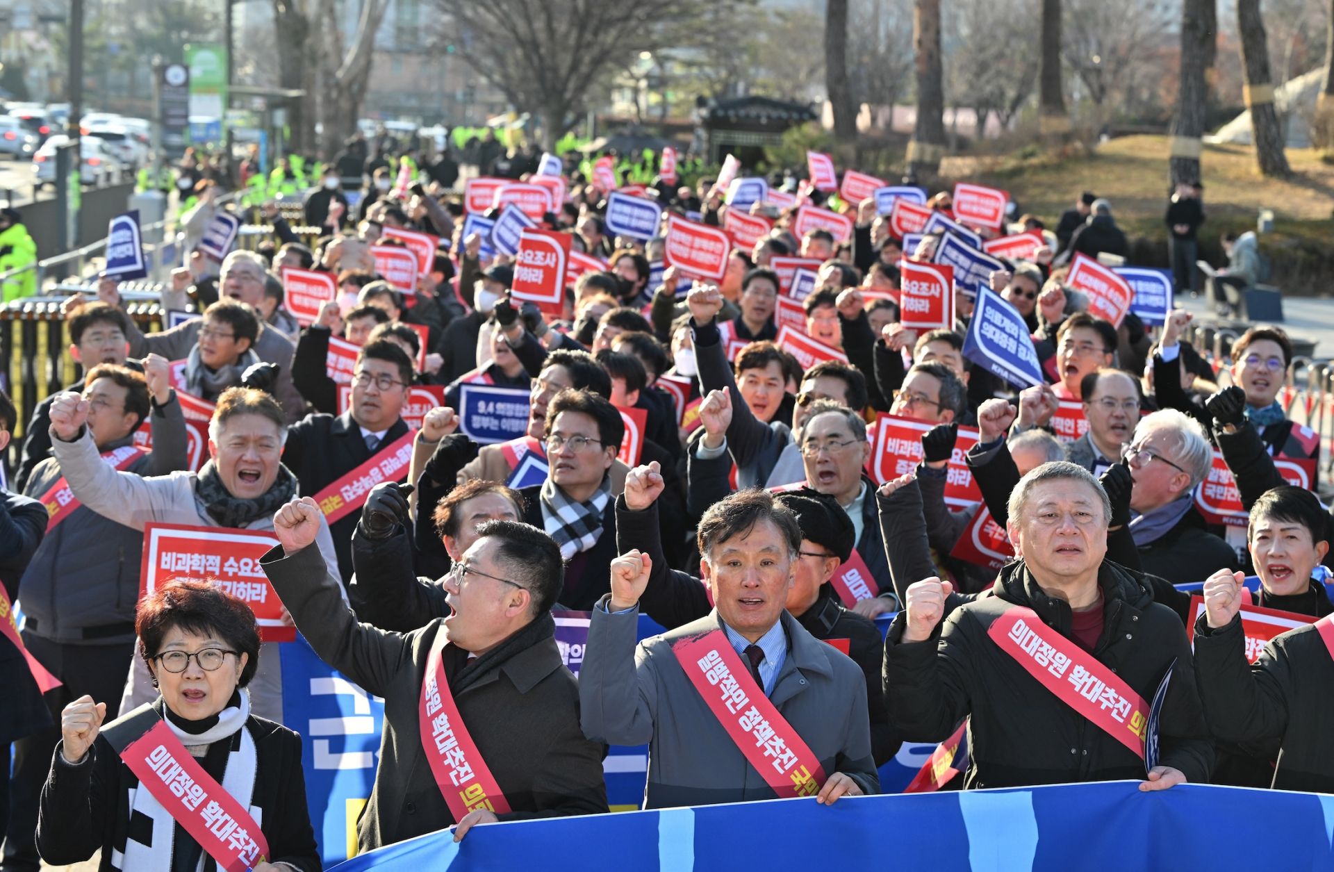 Doctors shout slogans during a rally to protest against the government's plan to raise the annual enrollment quota at medical schools, near the Presidential Office in Seoul on Feb. 25, 2024.