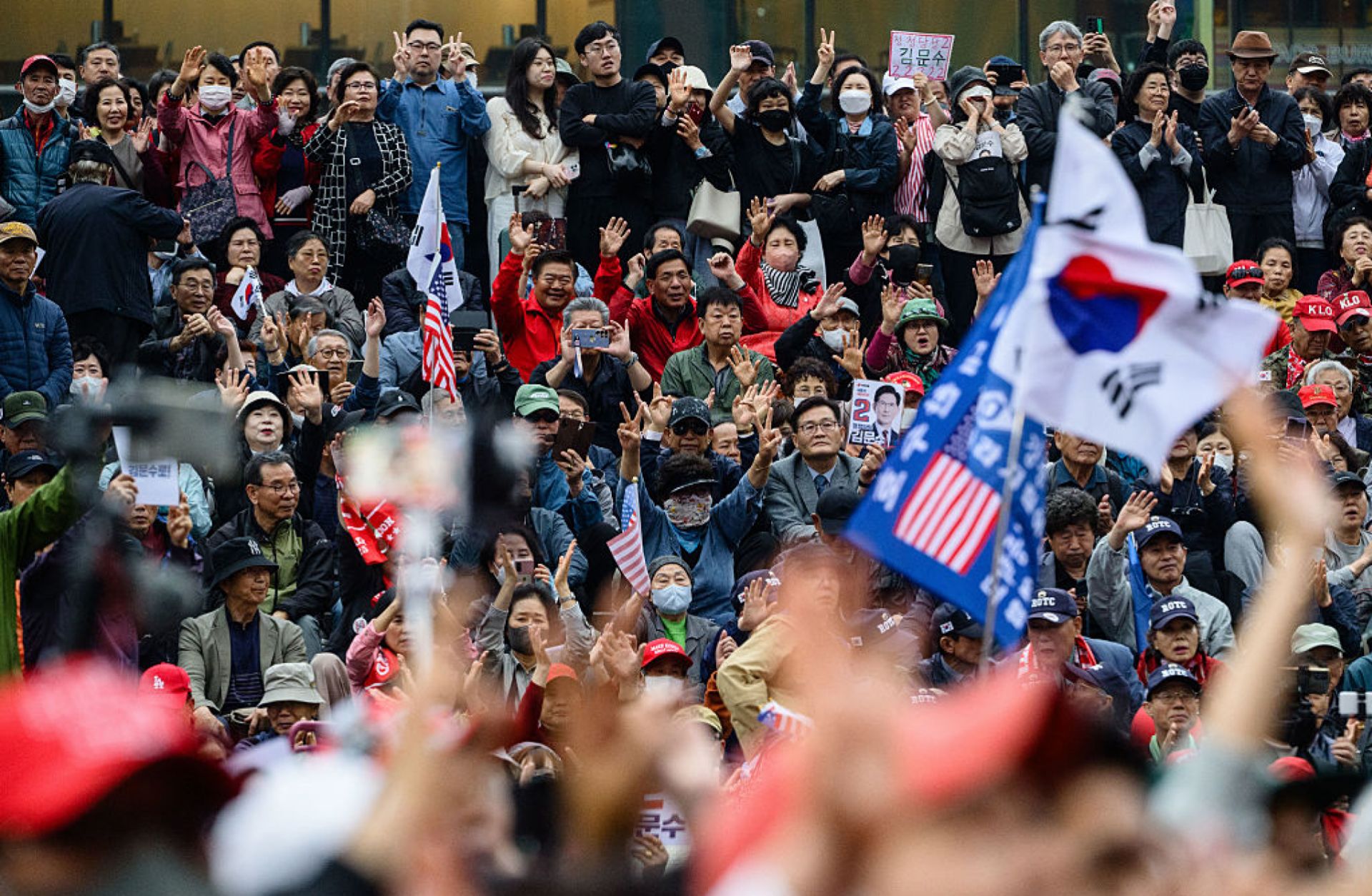 Supporters of Kim Moon Soo, the opposition candidate running in South Korea's June 3 presidential election, react during a campaign event in Seoul on May 19, 2025.