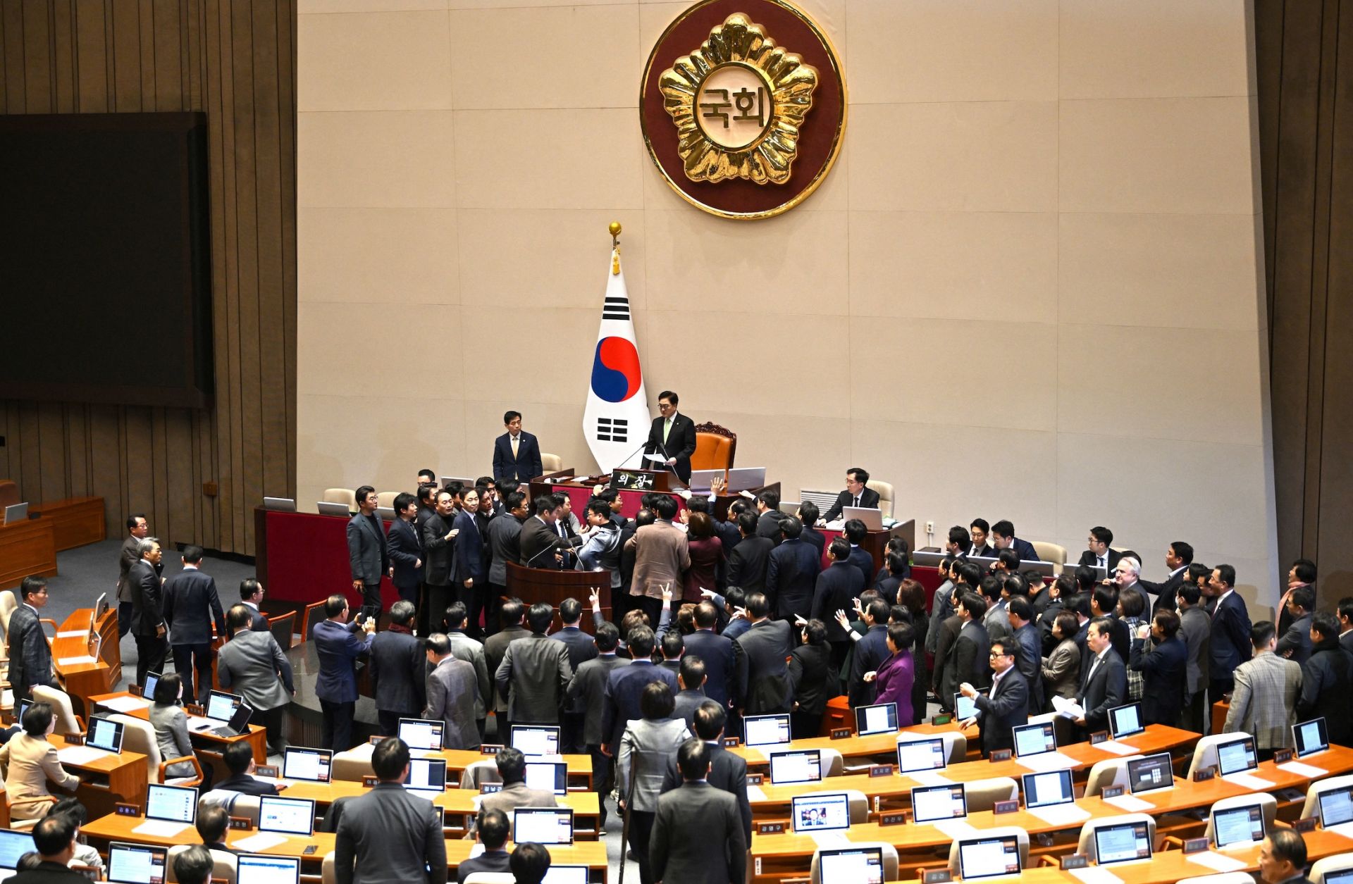 People Power Party lawmakers (bottom) argue with National Assembly Speaker Woo Won-shik (top) during the plenary session for the impeachment vote of acting president Han Duck-soo on Dec. 27, 2024, at the National Assembly in Seoul, South Korea.