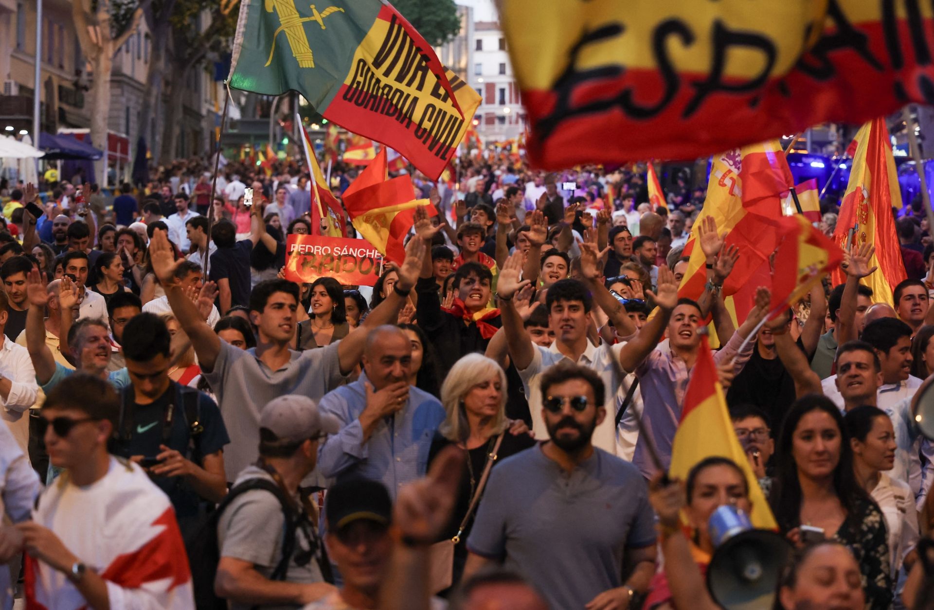Supporters of the far-right Vox party wave flags and shout slogans during a protest against Spanish Prime Minister Pedro Sanchez in Madrid, on June 13, 2025.