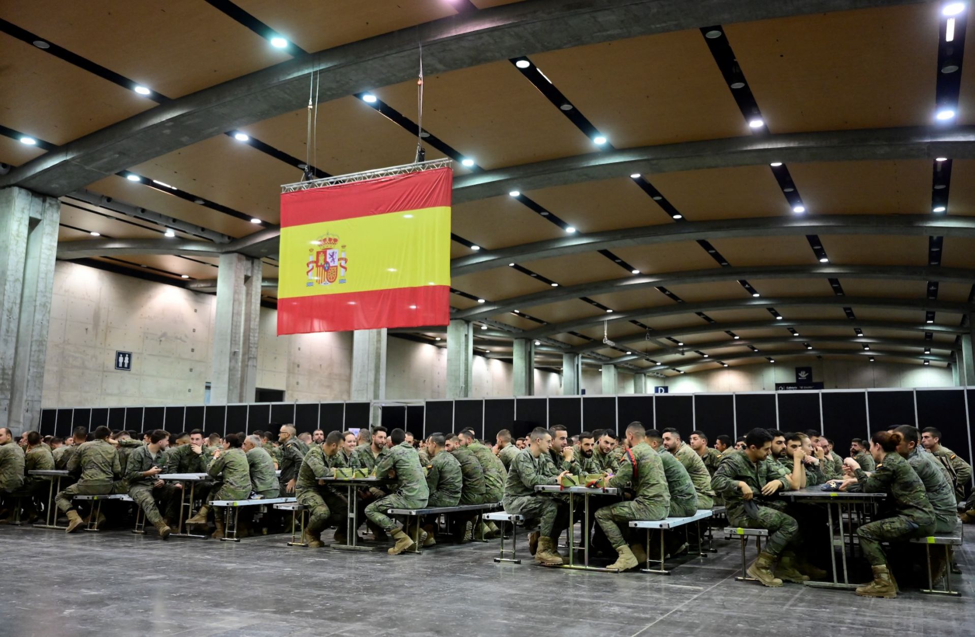 Spanish soldiers sit at tables at a makeshift military base in Valencia, eastern Spain, on Nov. 12, 2024, following deadly floods in the region. Spanish soldiers sit at tables at a makeshift military base in Valencia, eastern Spain, on Nov. 12, 2024, following deadly floods in the region.
