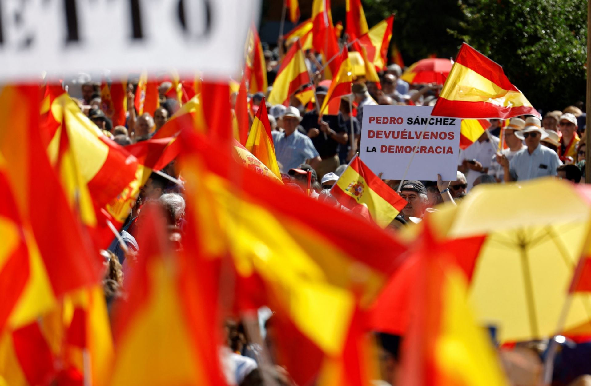 A protester holds a sign reading "Pedro Sanchez, give us back the democracy" during a demonstration in Madrid against Spanish Prime Minister Pedro Sanchez's government on June 8, 2025. A protester holds a sign reading "Pedro Sanchez, give us back the democracy" during a demonstration in Madrid against Spanish Prime Minister Pedro Sanchez's government on June 8, 2025.