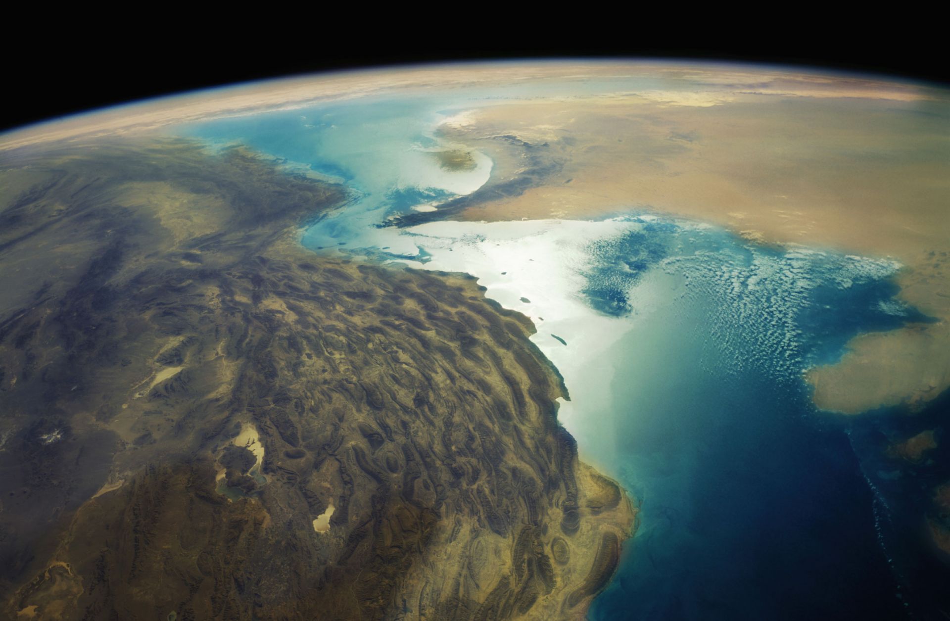 An aerial depiction of Iran's Zagros Mountains and the Strait of Hormuz.