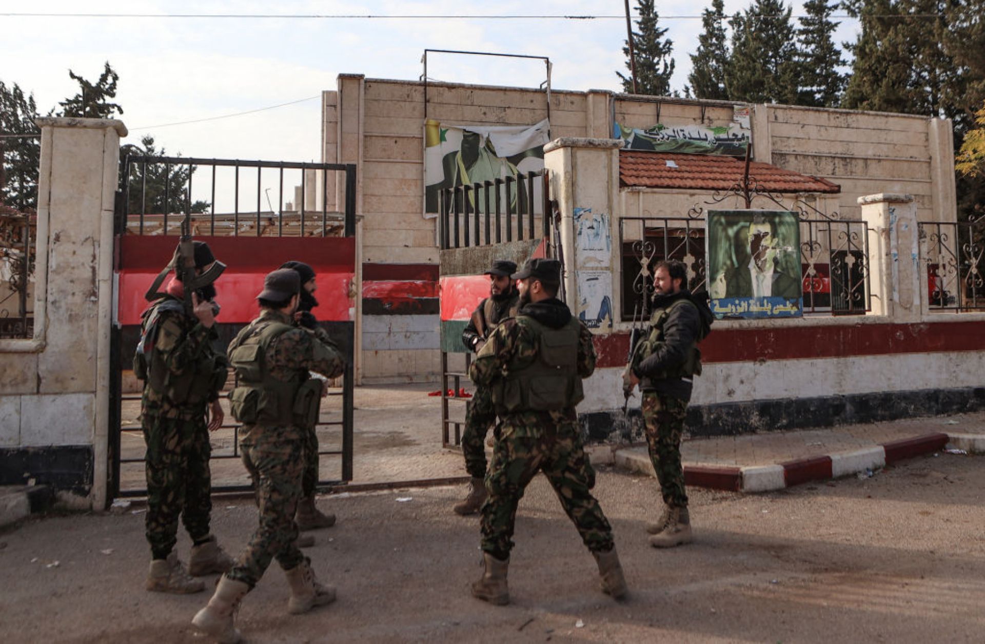 Fighters gather outside a building that was seized by jihadists in Syria's northern Aleppo province on Nov. 29, 2024, amid the Hayat Tahrir al-Sham (HTS) offensive against government forces.