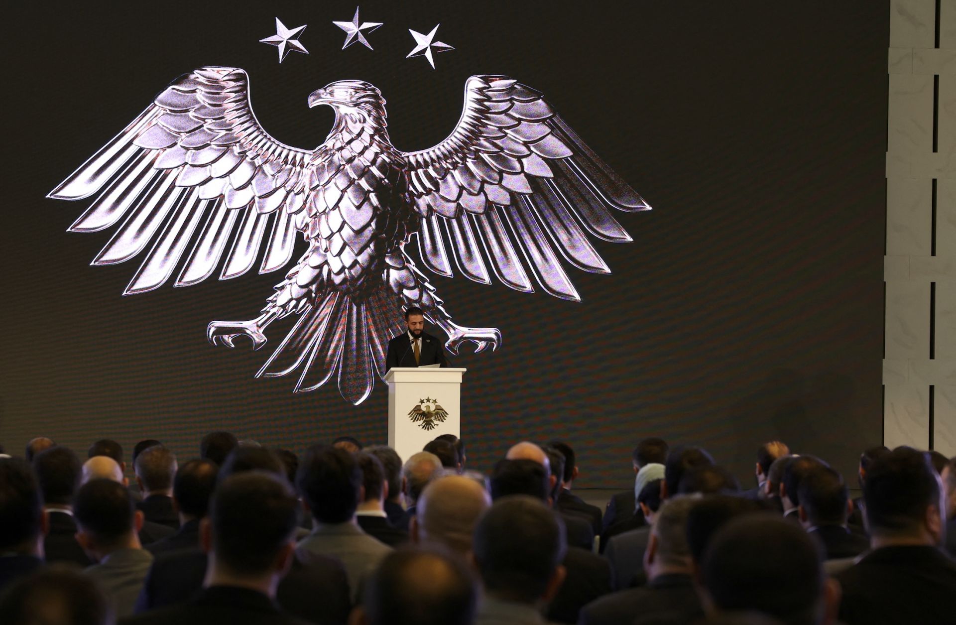 Syria's interim President Ahmad al-Sharaa delivers a speech in Damascus on July 3, 2025, during the unveiling of the "New Visual Identity of the Syrian Arab Republic." 