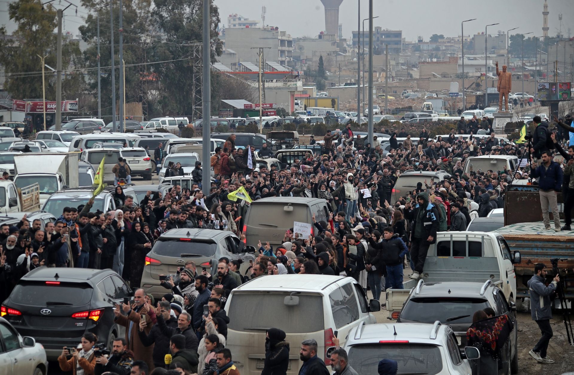 Citizens gather to welcome the arrival of vehicles transporting Kurdish fighters from the northern city of Aleppo to the Kurdish-controlled northeastern city of Qamishli on Jan. 11, 2026.