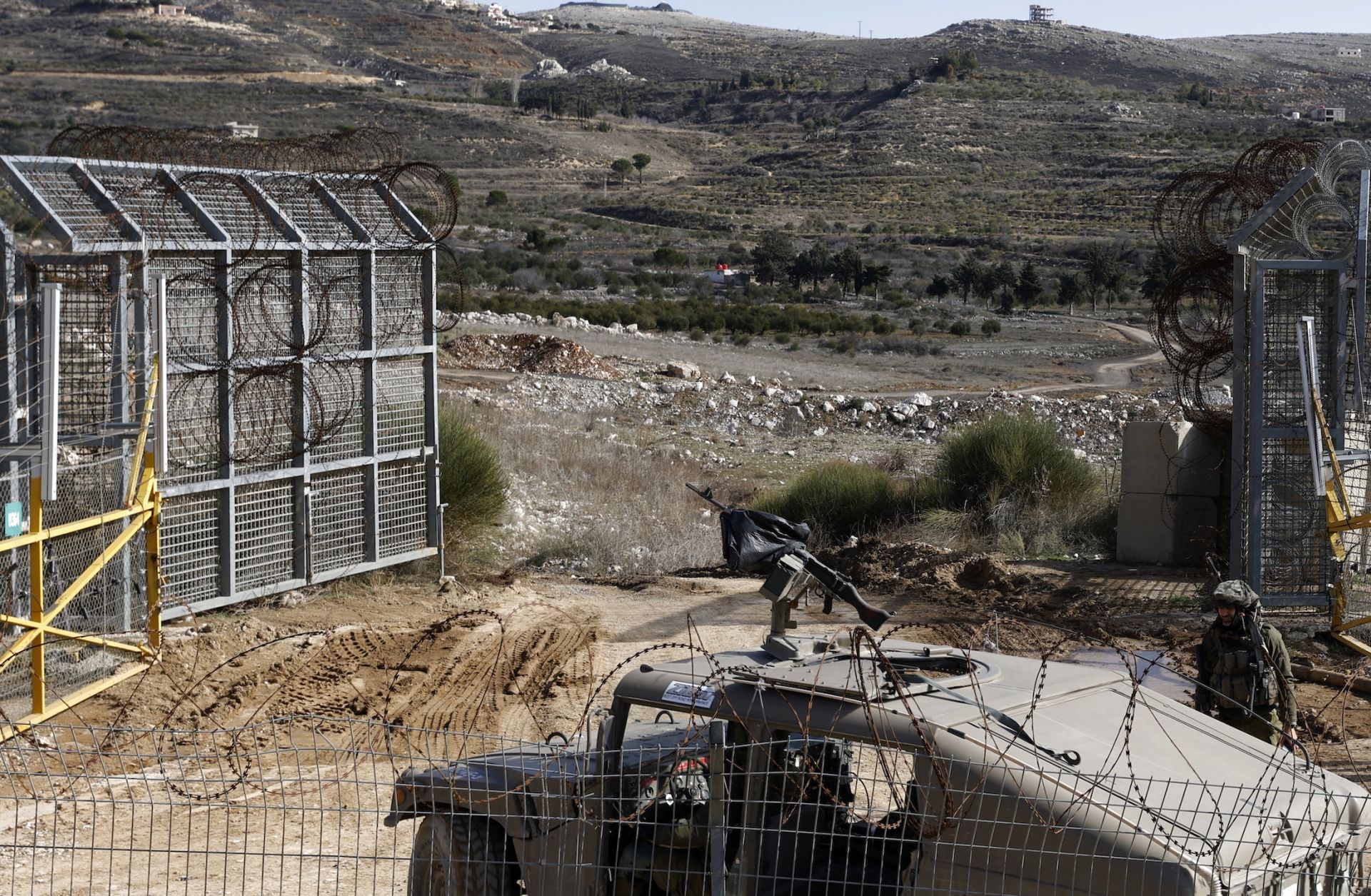 An Israeli army vehicle patrols near the fence leading into the U.N.-patrolled buffer zone, which separates Israeli and Syrian forces in the Golan Heights, on Jan. 5, 2025. 