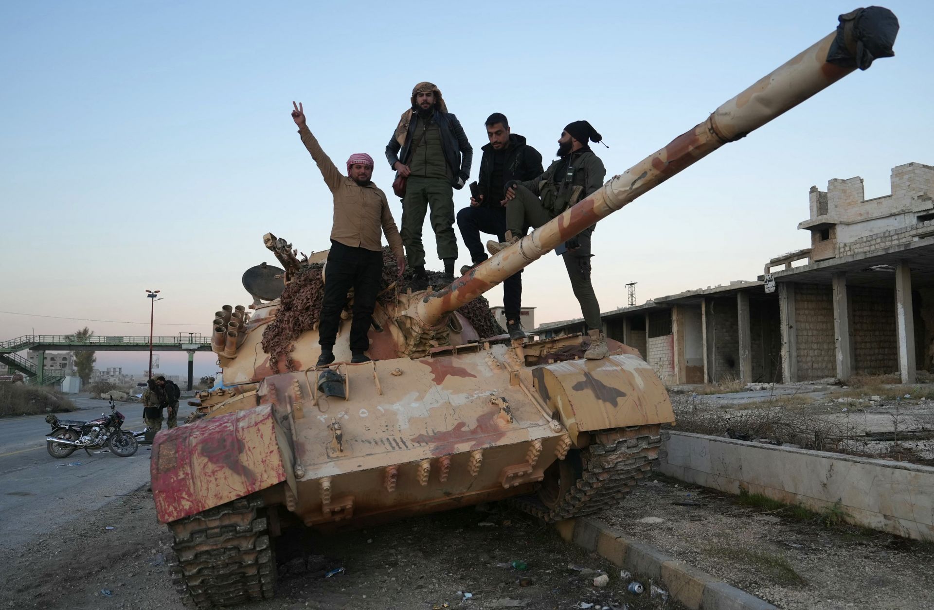 Rebel fighters pose for a picture on a tank on a road leading to Syria's northwestern Idlib province on Nov. 30, 2024. 